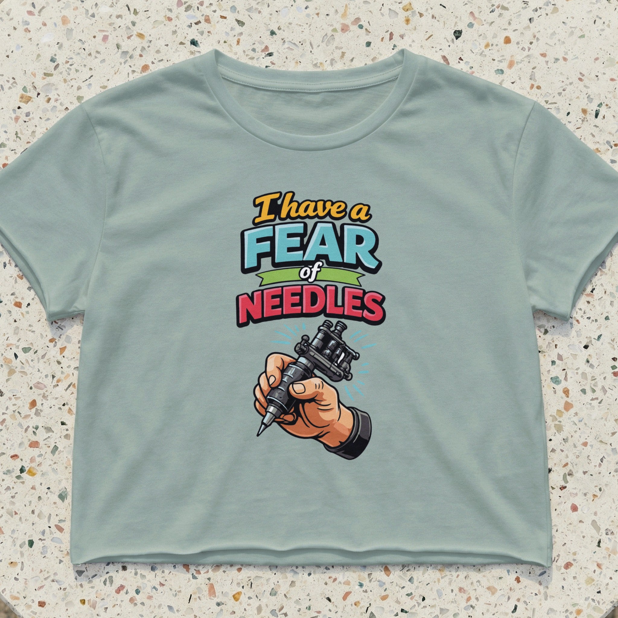 Crop top with text "I have a fear of NEEDLES" and a tattoo gun.