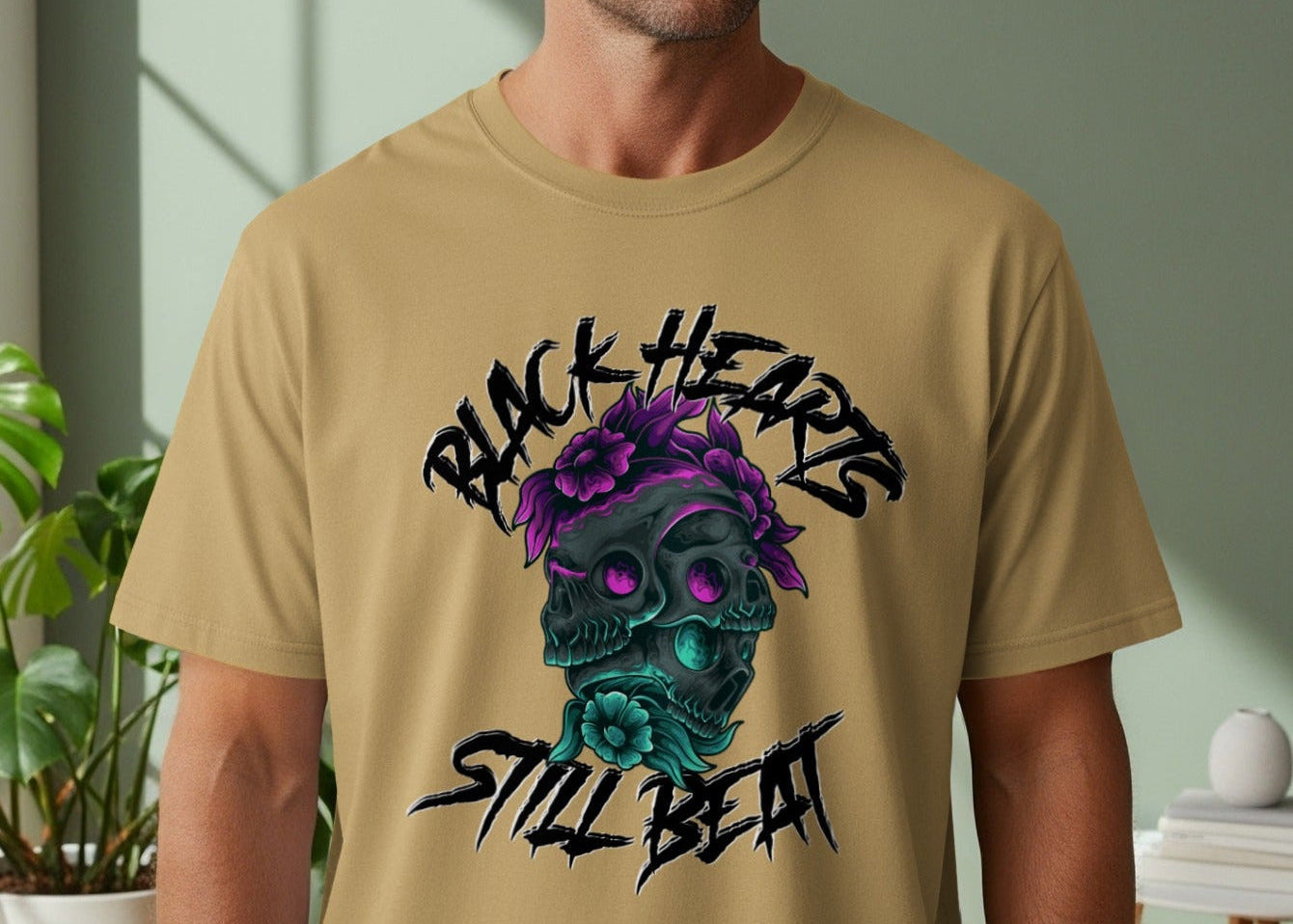 Tan t-shirt with black text and skull graphic with purple flowers.