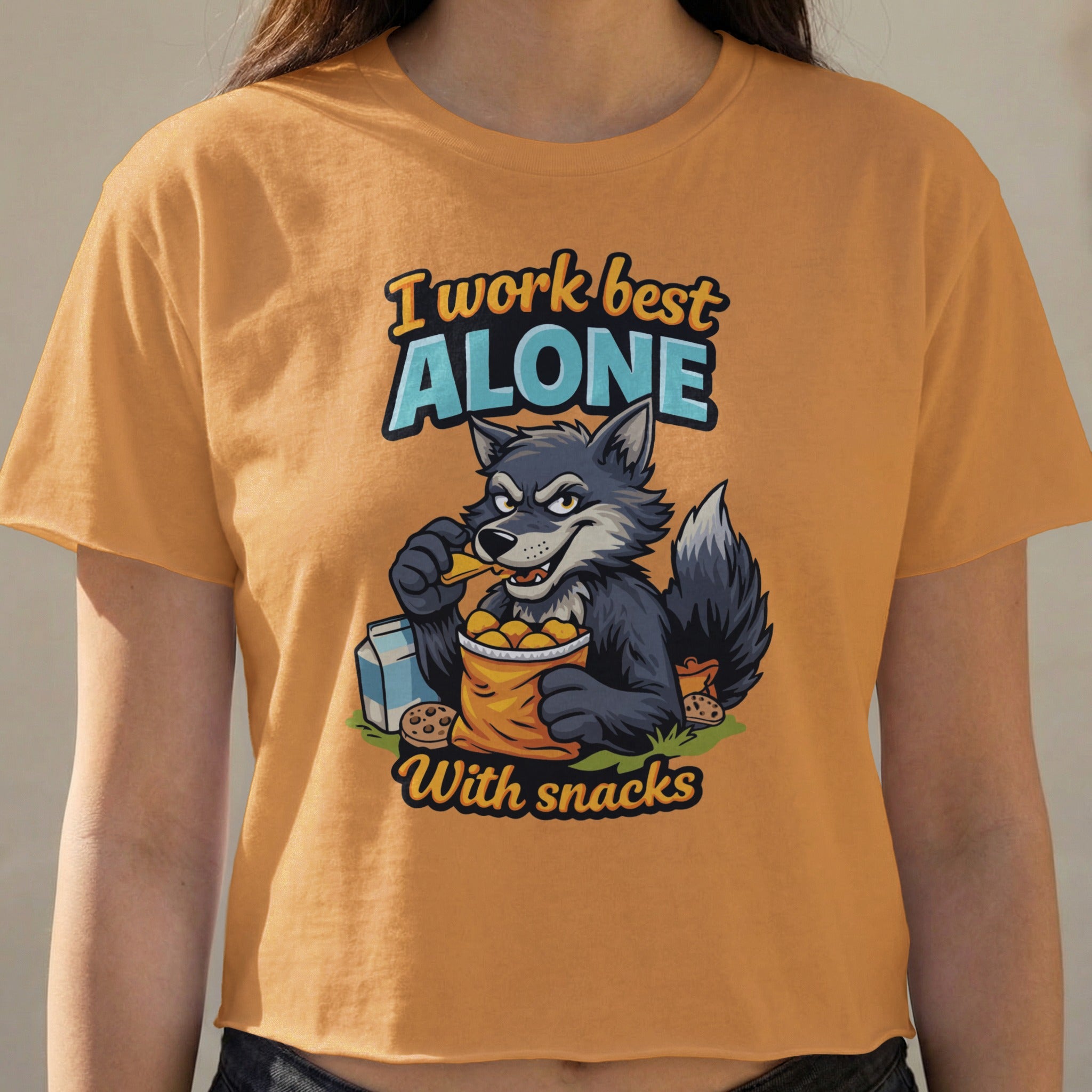 Wolf character wearing t-shirt that says "I work best alone with snacks".