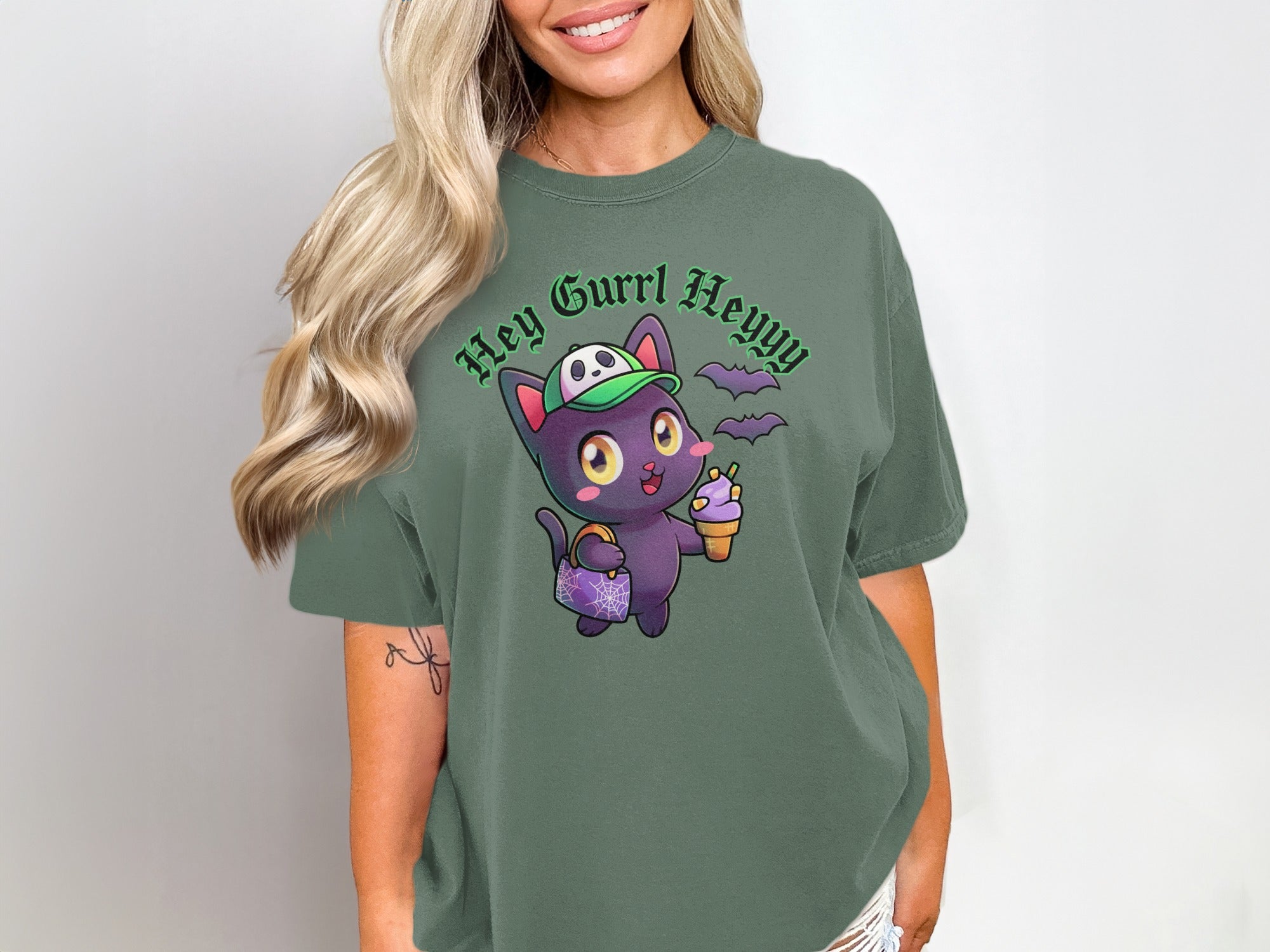 Graphic t-shirt with a cartoon black cat wearing a hat and holding ice cream.