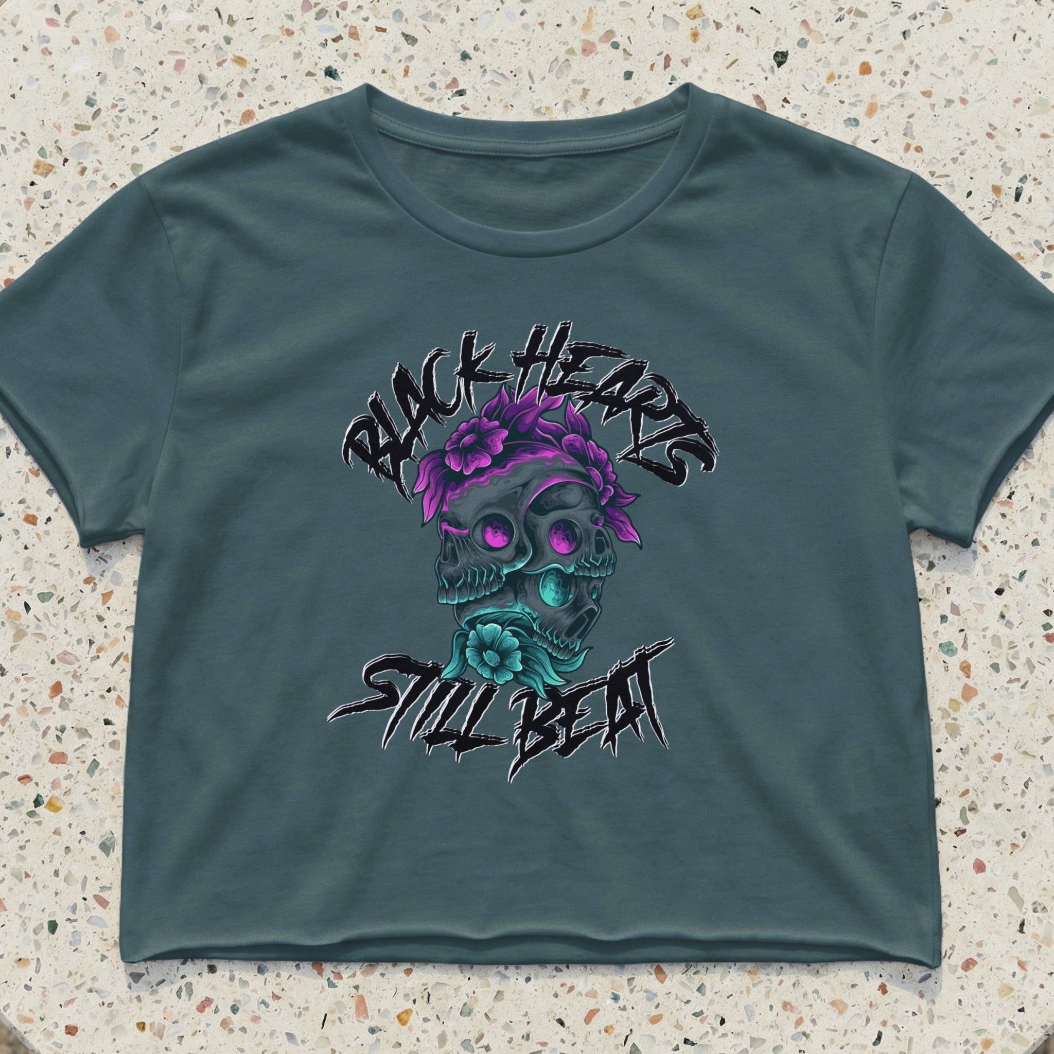 Crop top with skulls, flowers, and "Black Hearts Still Beat" text.