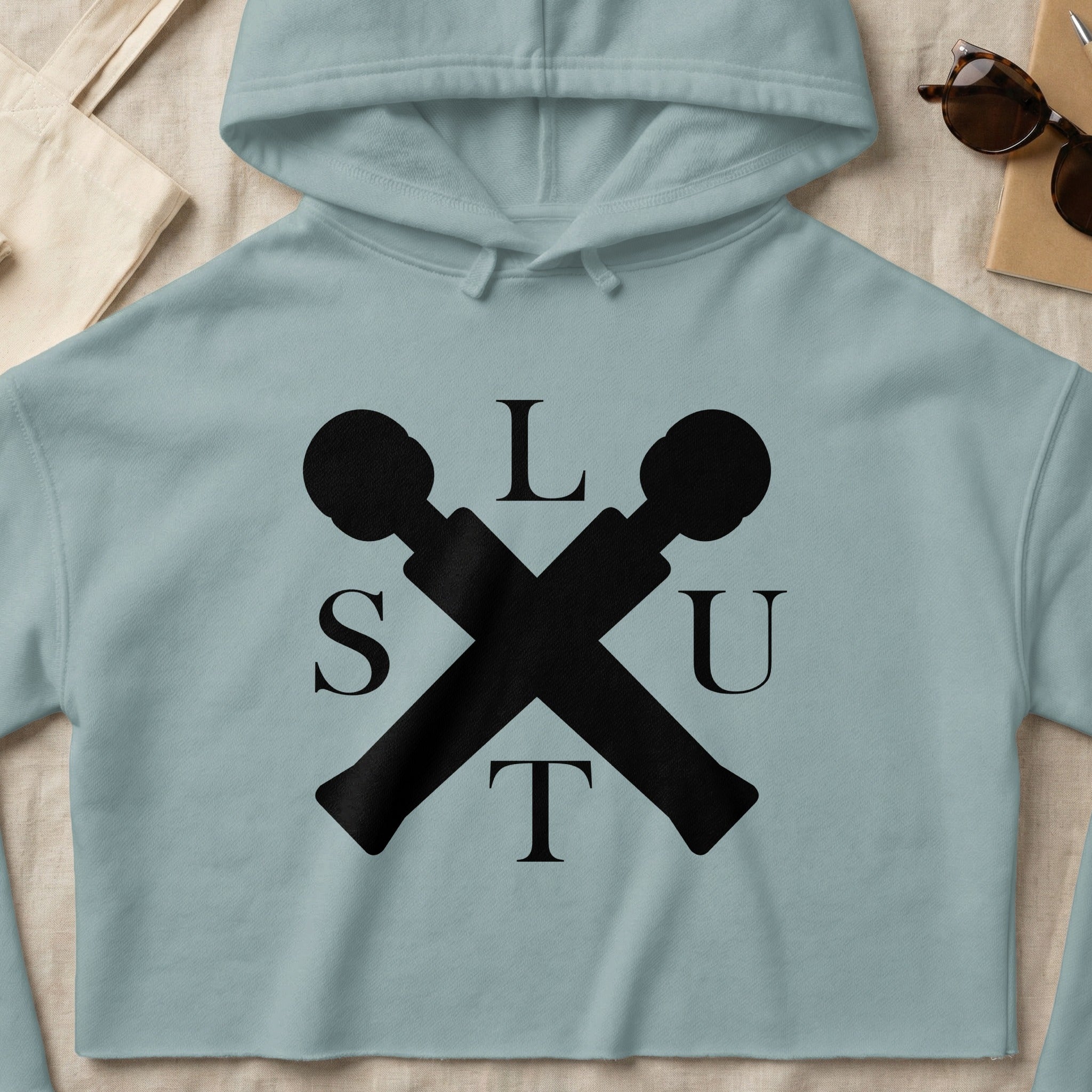 Light blue cropped hoodie with black "SLUT" logo in vintage microphone design.