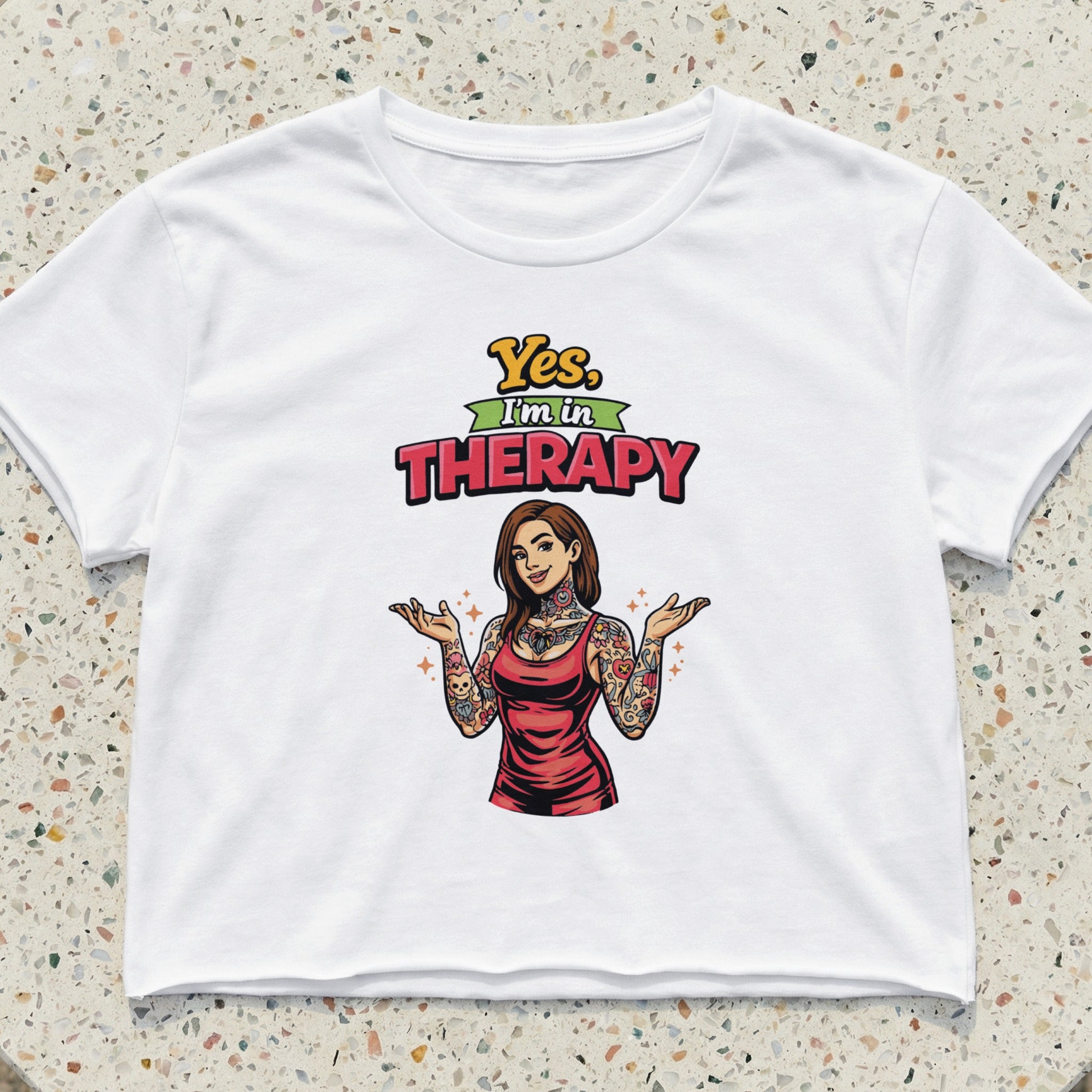 White crop top with "Yes, I'm in THERAPY" text and tattooed woman graphic.