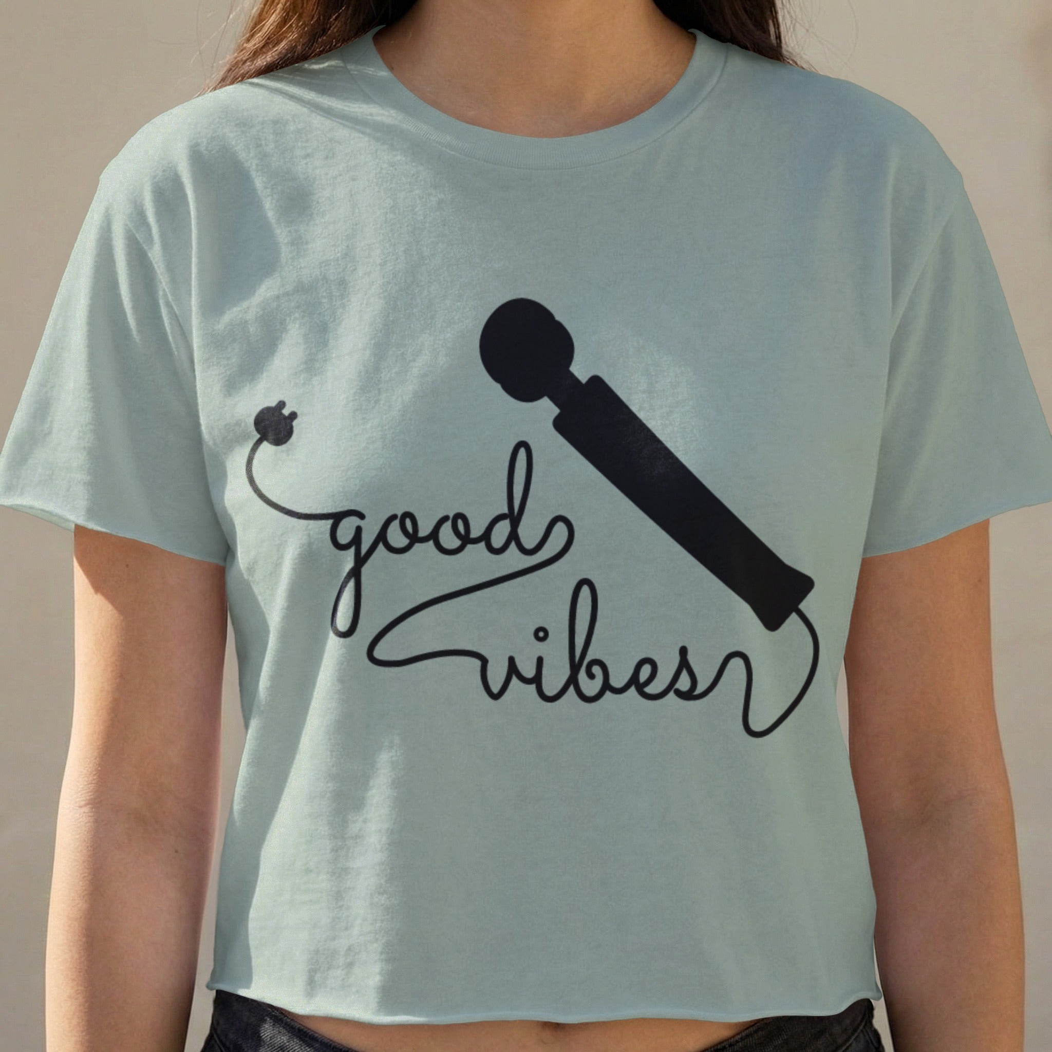 Light blue cropped t-shirt with "good vibes" text and a silhouette of a wand.