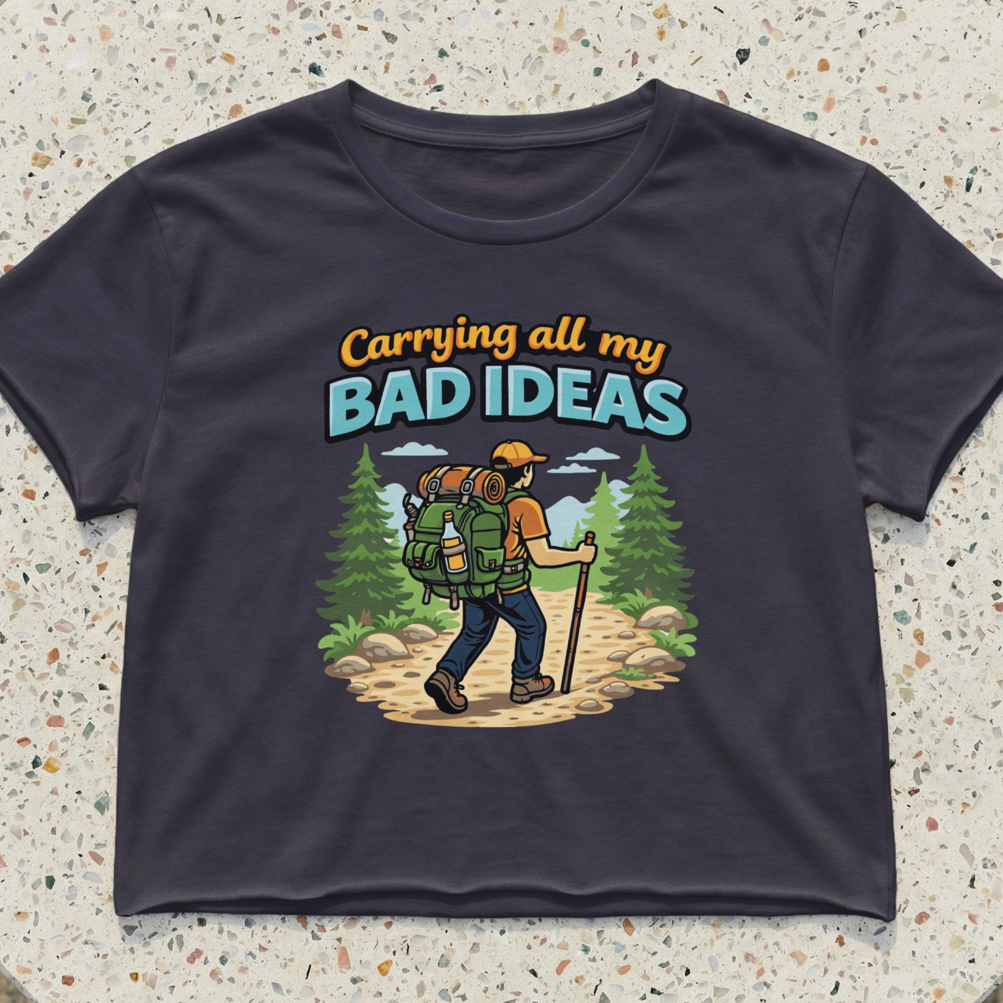 Woman hiking with backpack, text "Carrying all my BAD IDEAS".