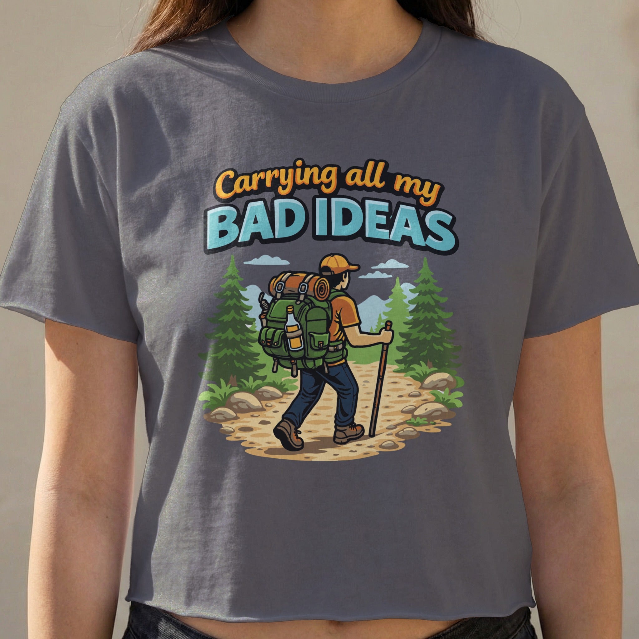 Gray t-shirt with graphic of hiker carrying "BAD IDEAS" backpack.