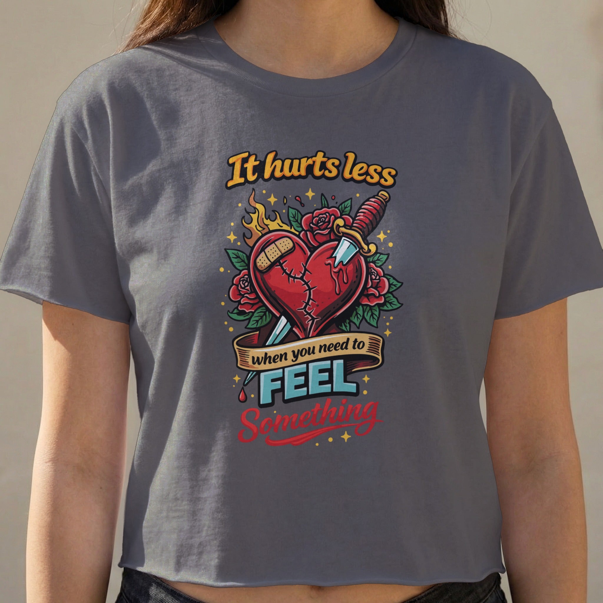 Dark gray cropped t-shirt with a graphic of a broken heart stabbed by a knife.
