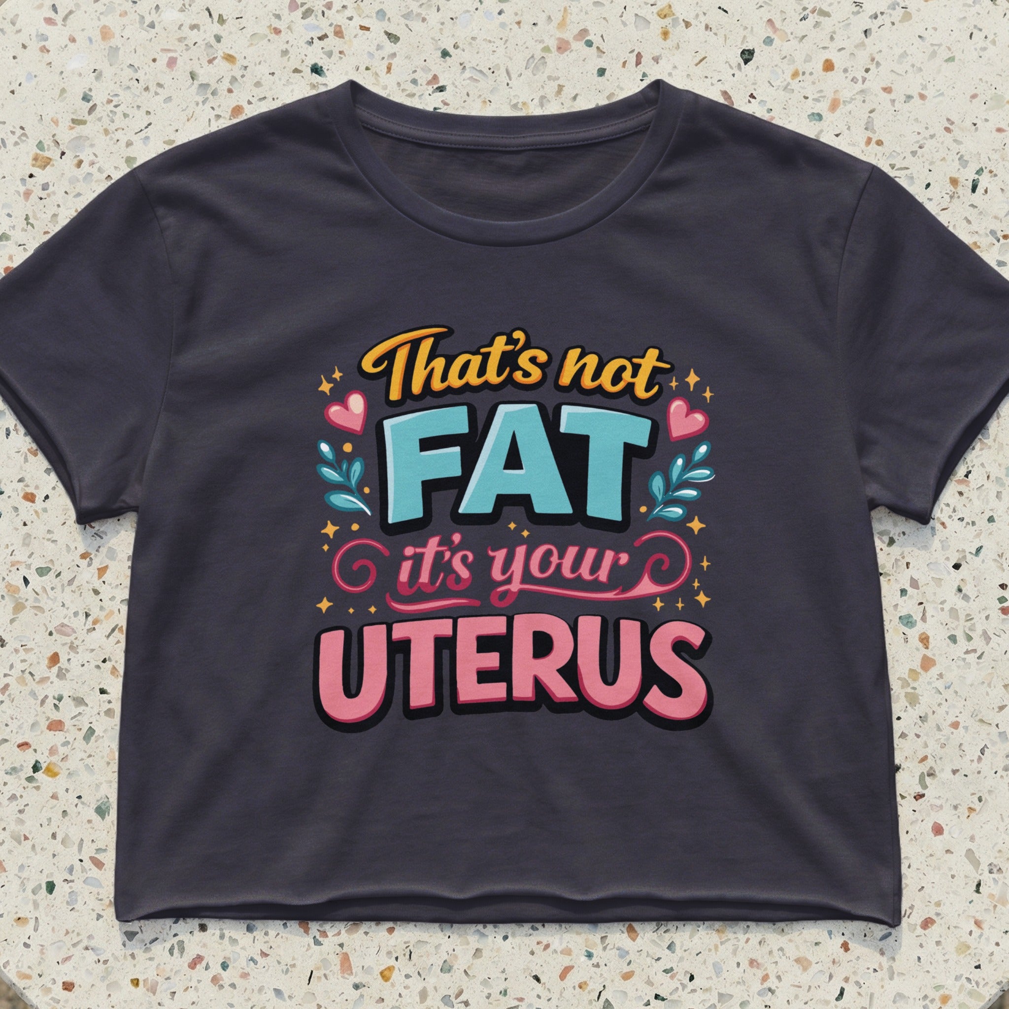 Crop top with text "That's not FAT it's your UTERUS" in pink and yellow.