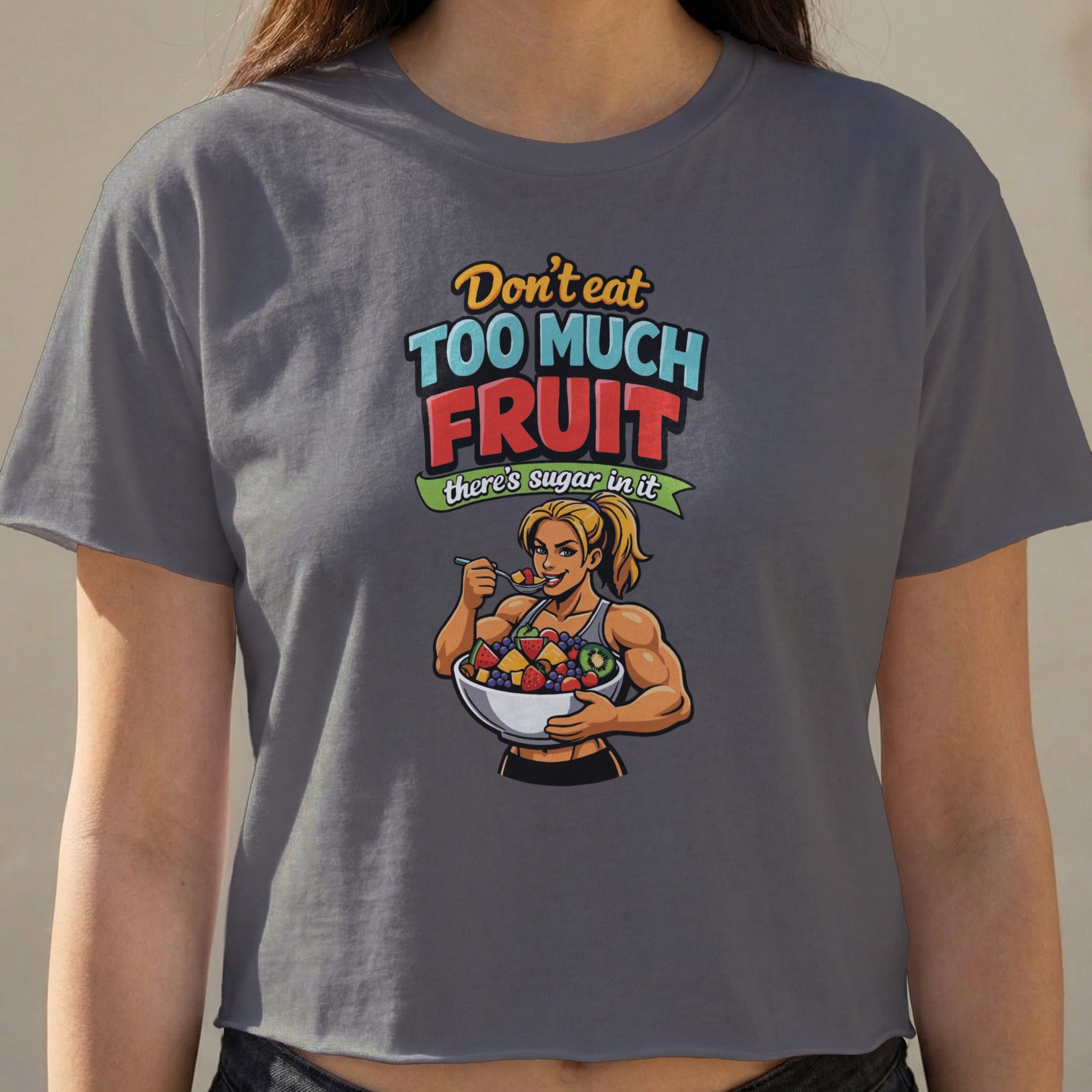 T-shirt with graphic of fit woman eating fruit, text "Don't eat too much fruit there's sugar in it."
