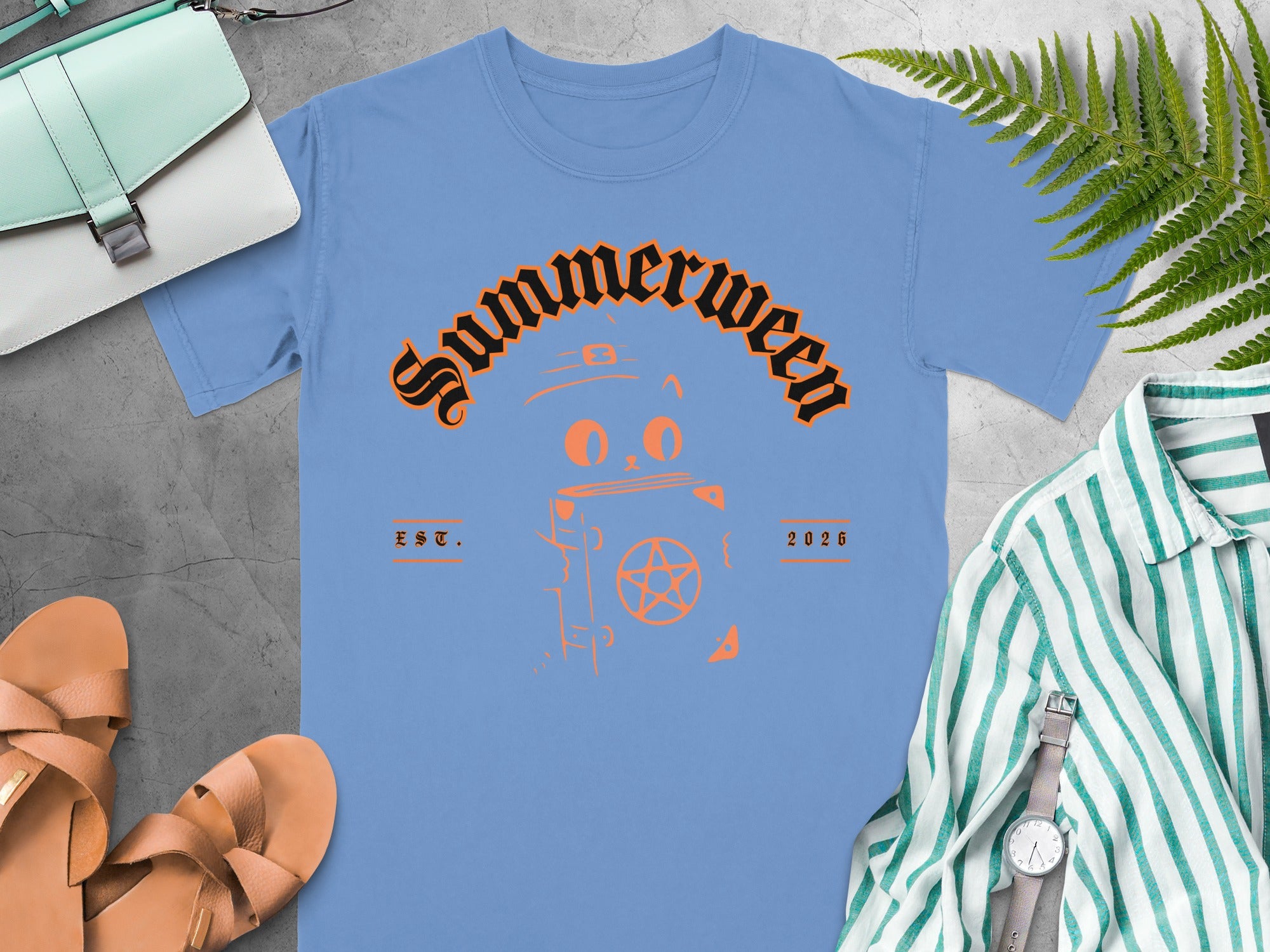 Light blue t-shirt with "Summerween" text and cat graphic, EST. 2026.