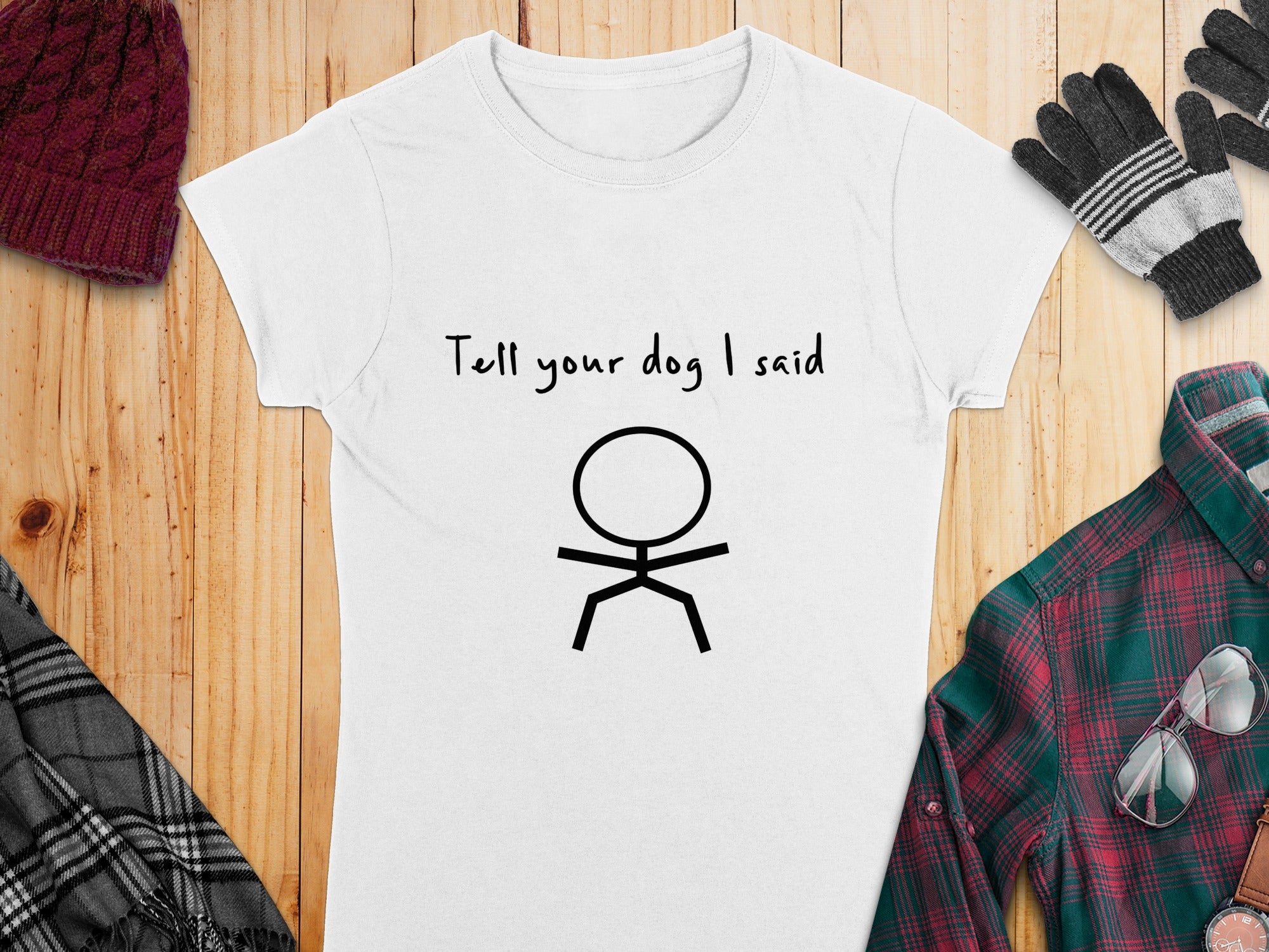 White t-shirt with black stick figure and "Tell your dog I said" text.