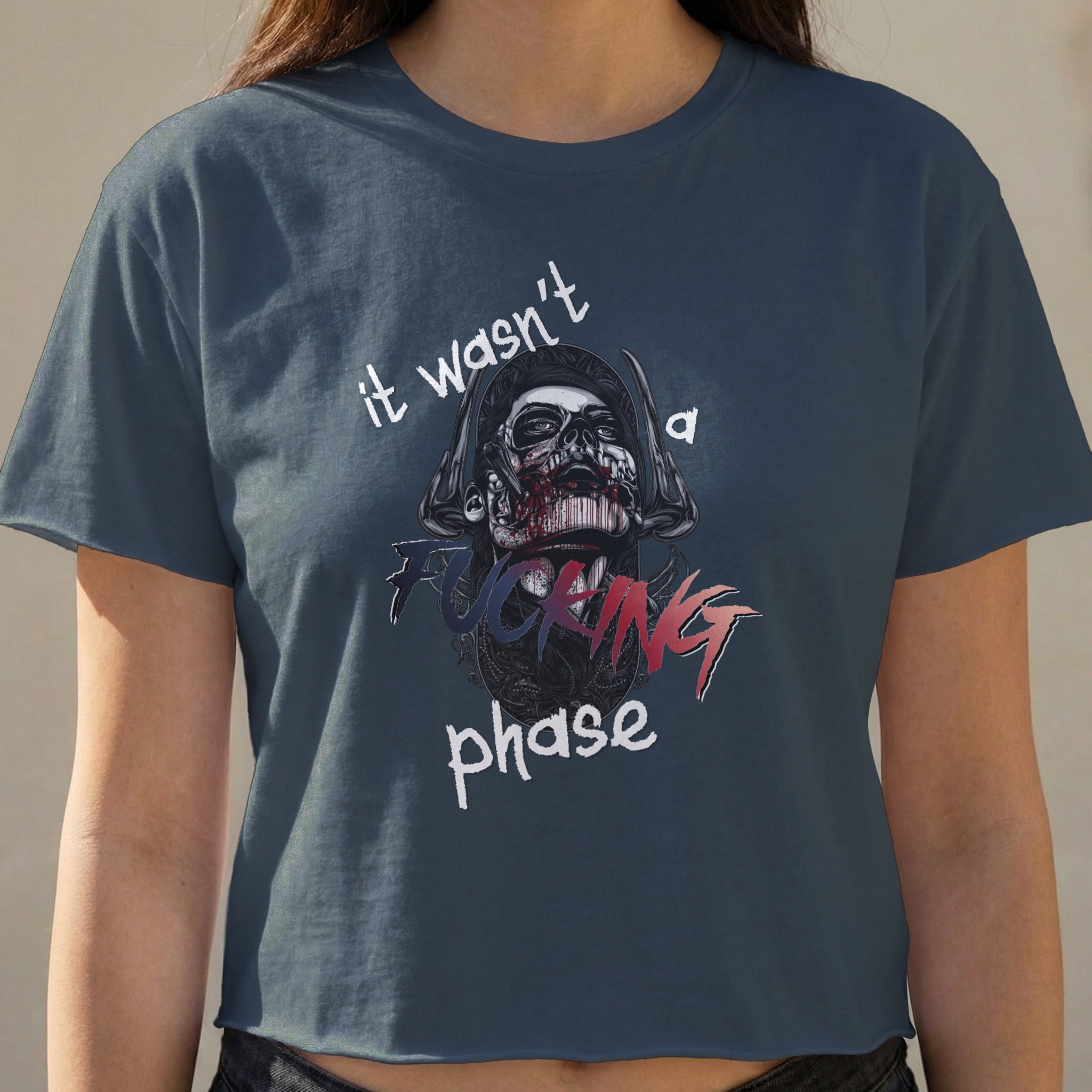 Dark blue crop top featuring a skull graphic with text "it wasn't a phase".