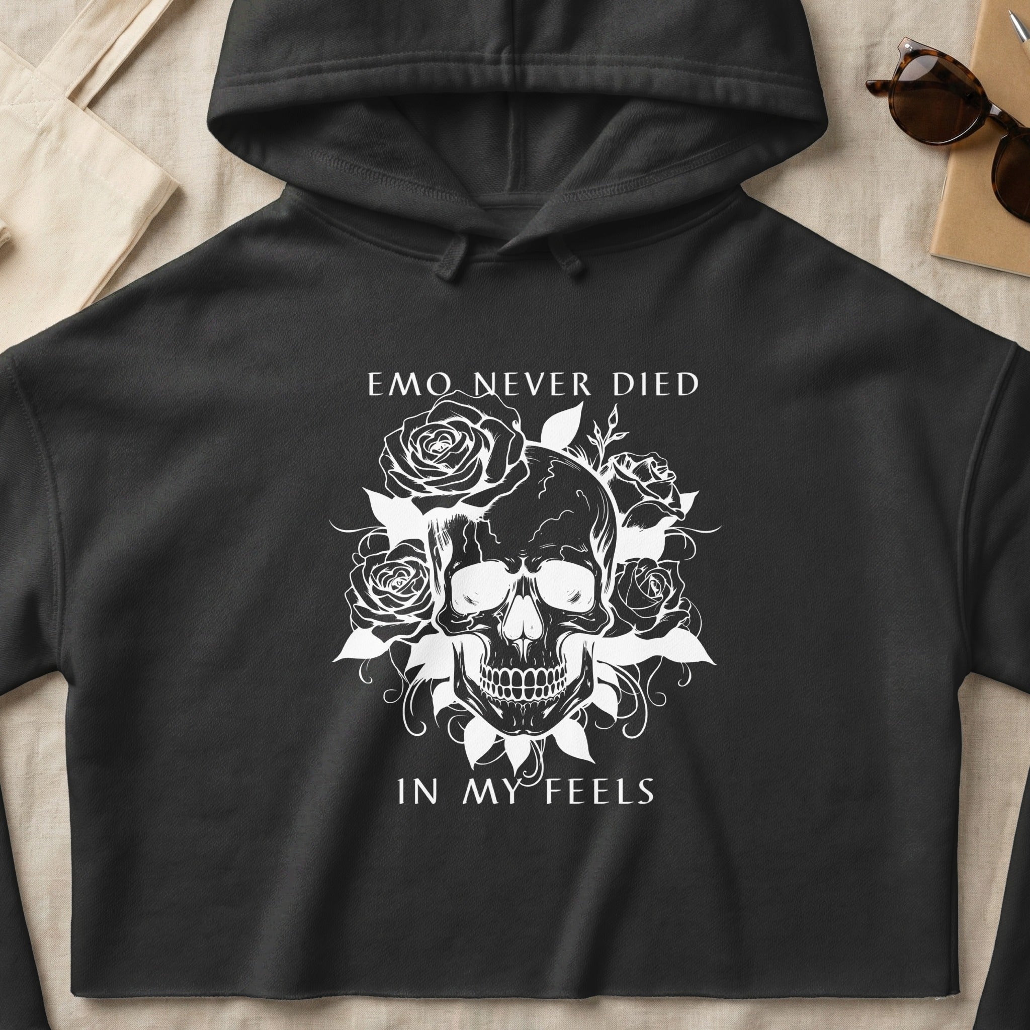 Black hoodie with a white graphic of a skull surrounded by roses and text.
