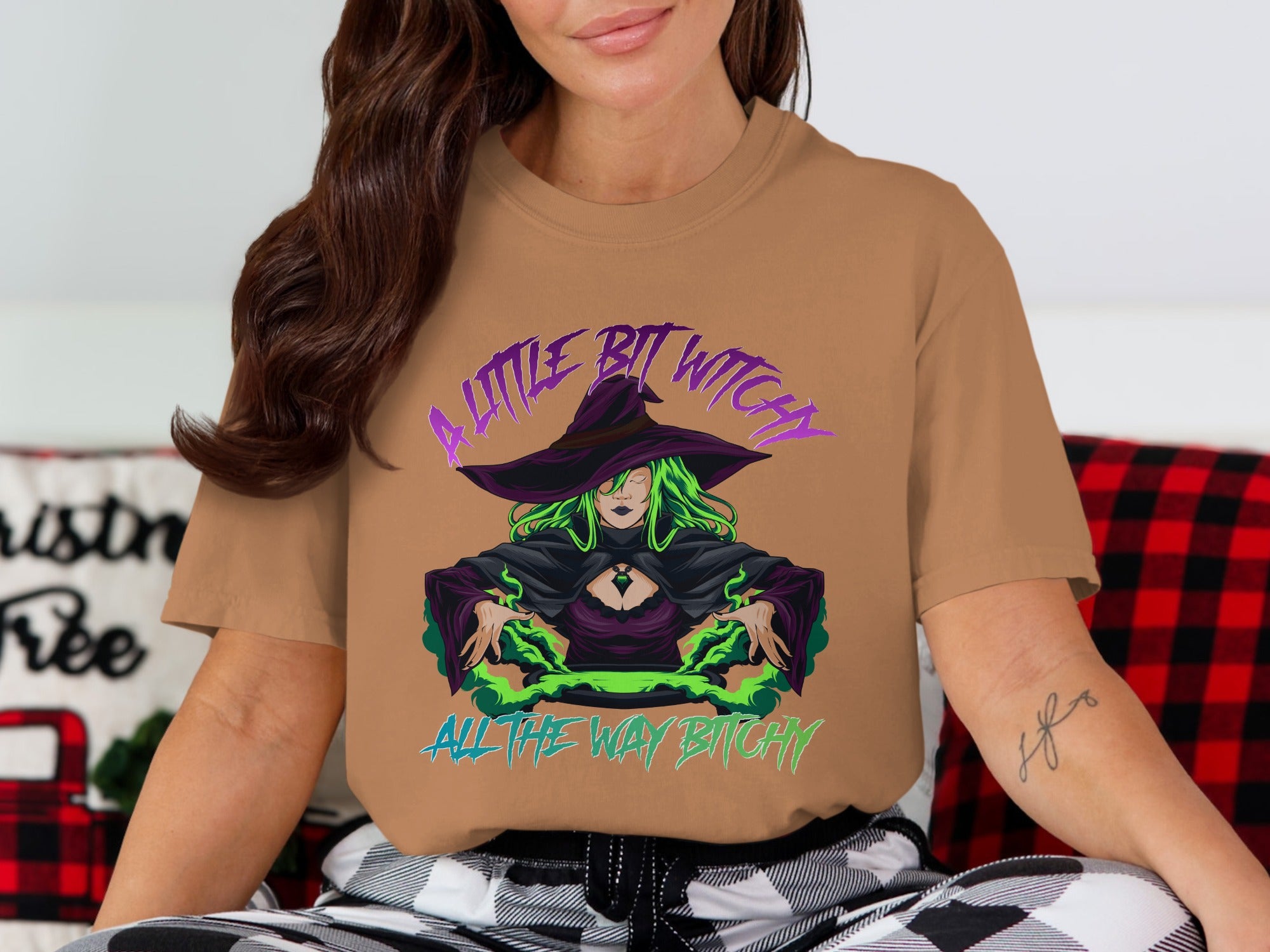 Tan t-shirt with witch graphic and text "A little bit witchy all the way bitchy."