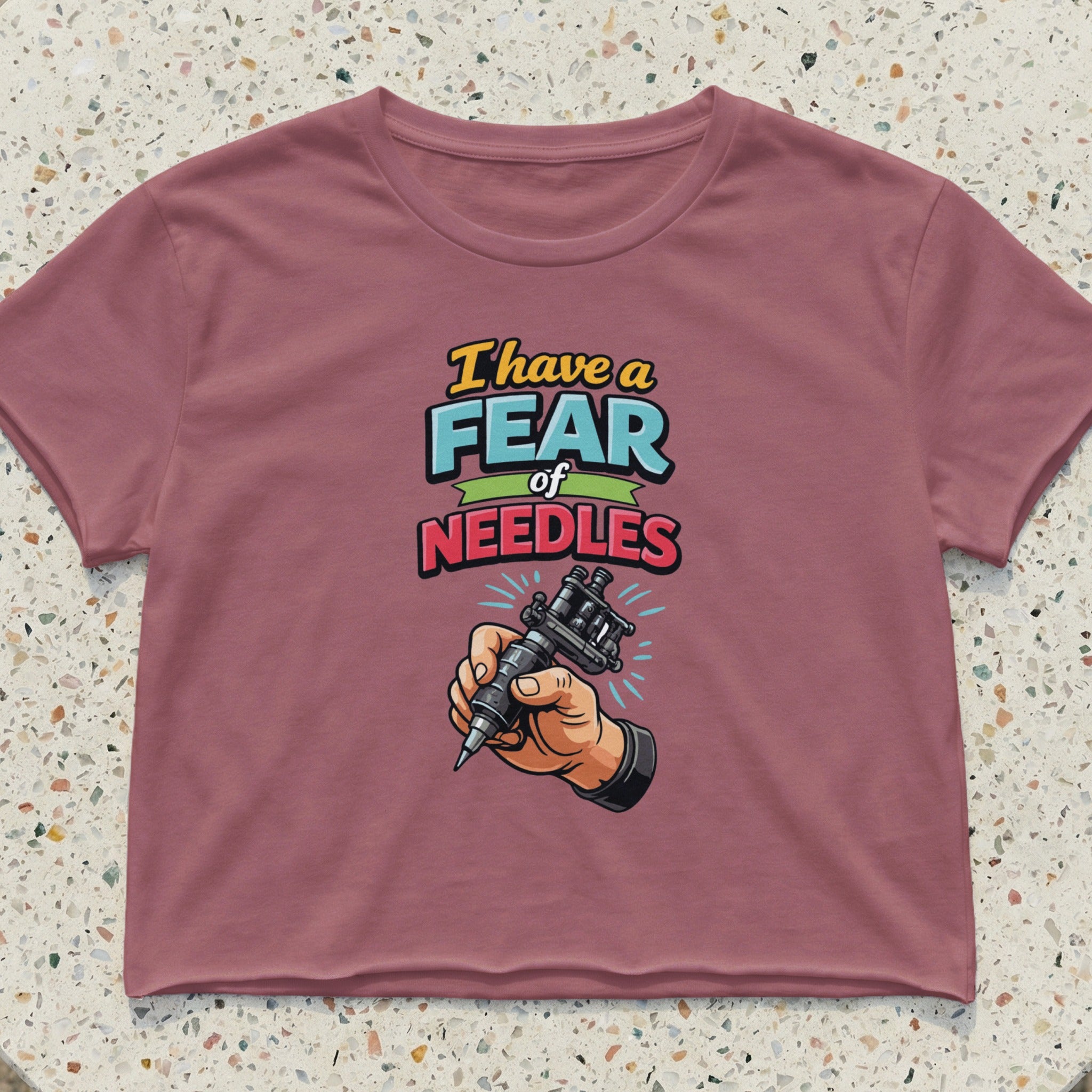 Cropped t-shirt with "I have a fear of NEEDLES" graphic and tattoo gun.