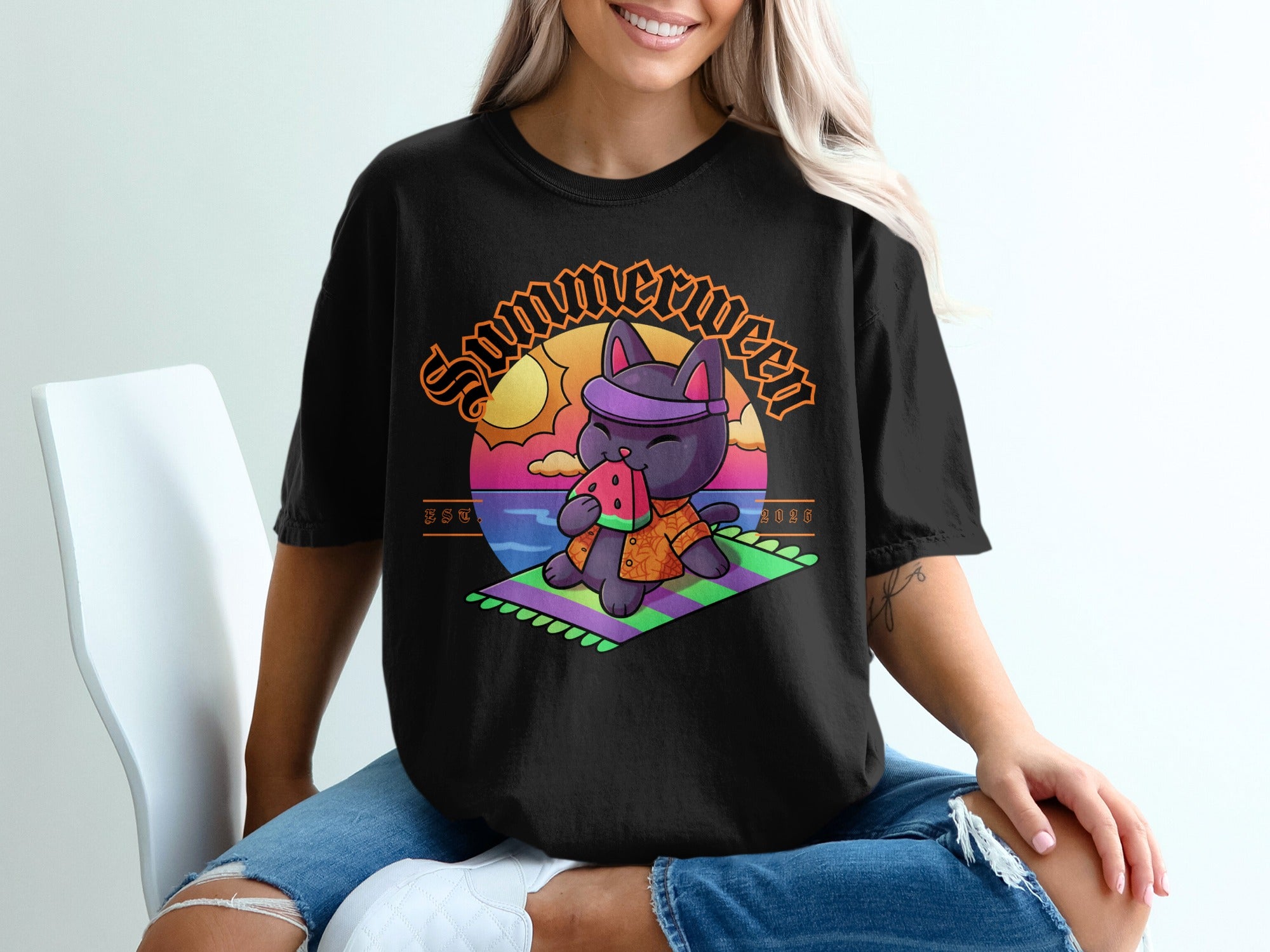 Black t-shirt with a cartoon black cat eating watermelon on a beach.