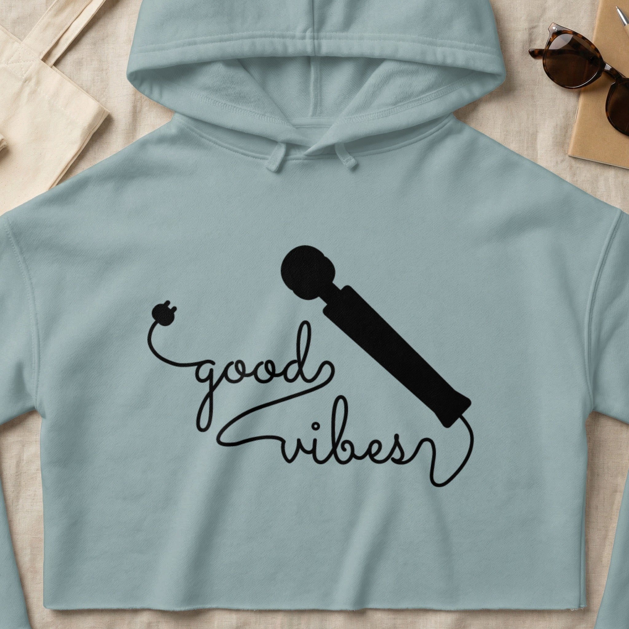 Light blue cropped hoodie with "good vibes" text and a vibrator graphic.