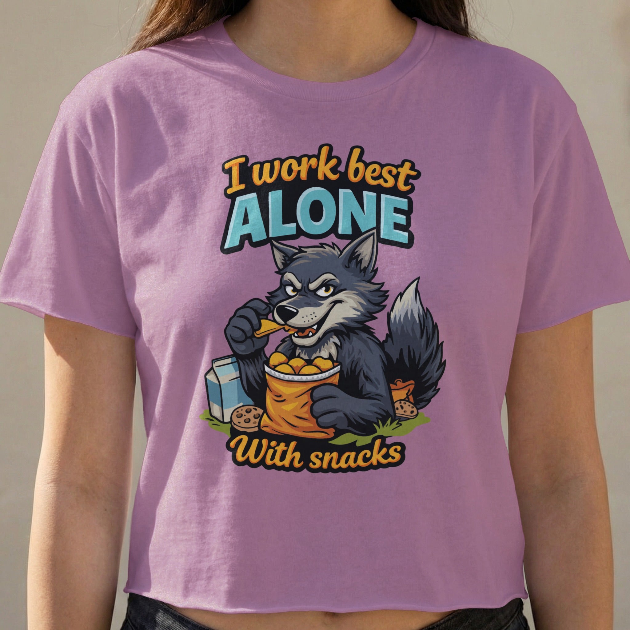 Purple t-shirt with a cartoon wolf eating snacks, text reads "I work best alone with snacks."