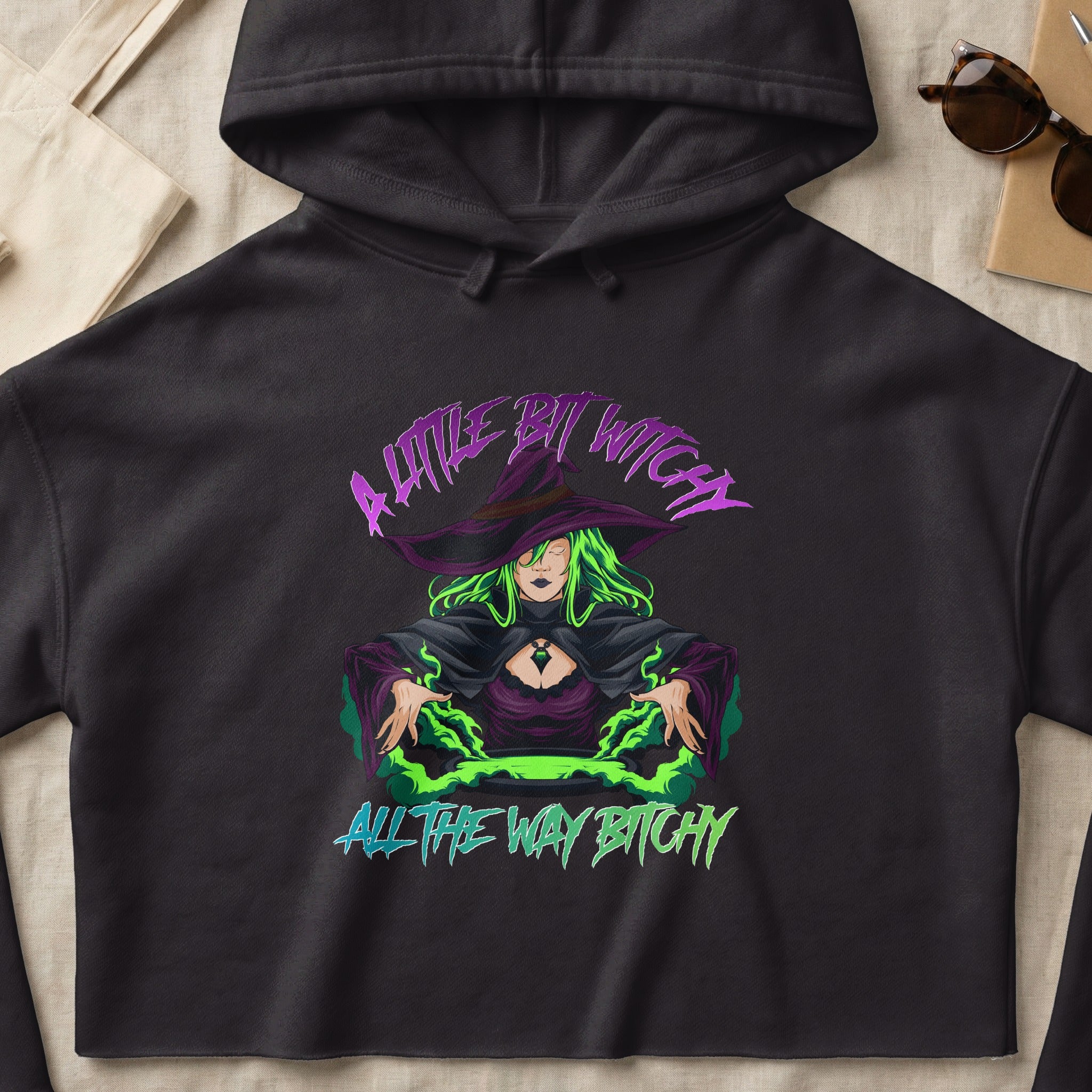 Black hoodie with "A little bit witch all the way bitch" and witch graphic.