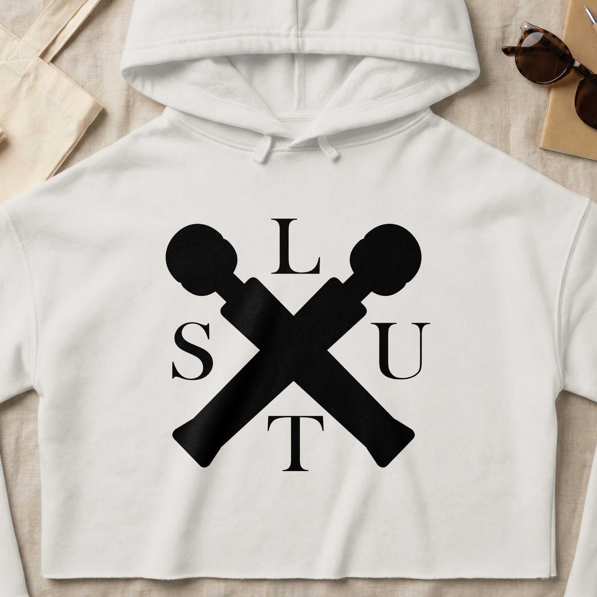 White cropped hoodie with black "SLUT" logo featuring crossed microphones.