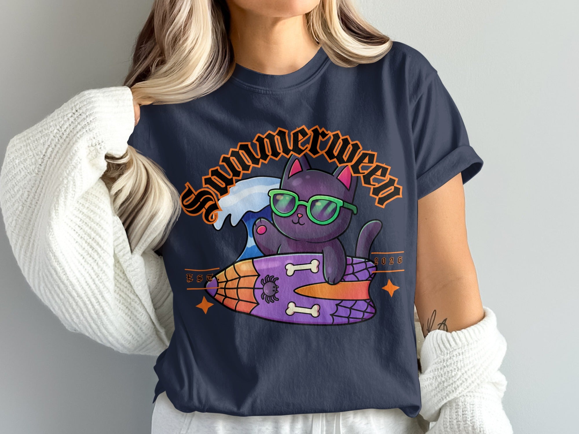 Black cat wearing sunglasses surfing on a surfboard with "Summerween 2026" text.