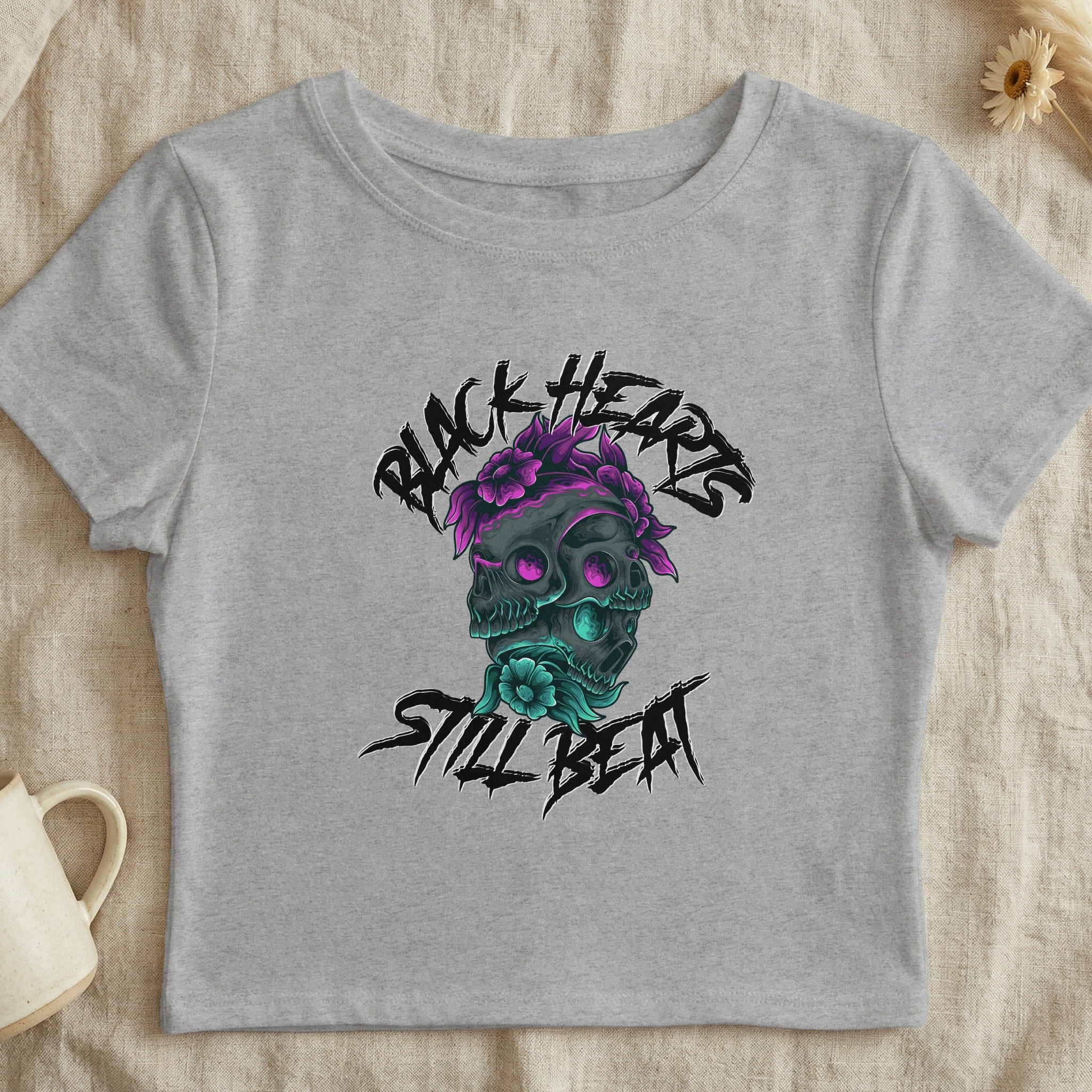Grey crop top with black hearts and skull graphic, "Black Hearts Still Beat" text.