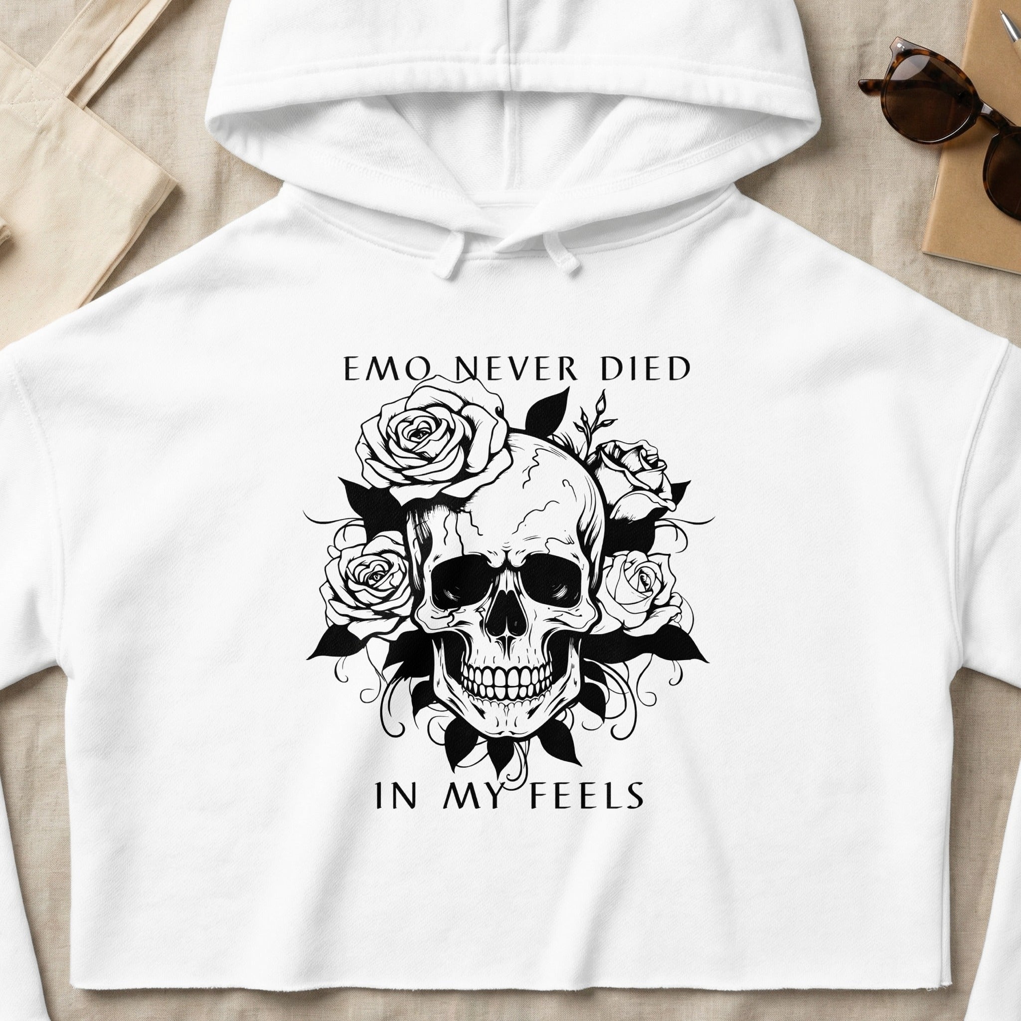 White crop hoodie with skull and rose graphic and text "EMO NEVER DIED IN MY FEELS".