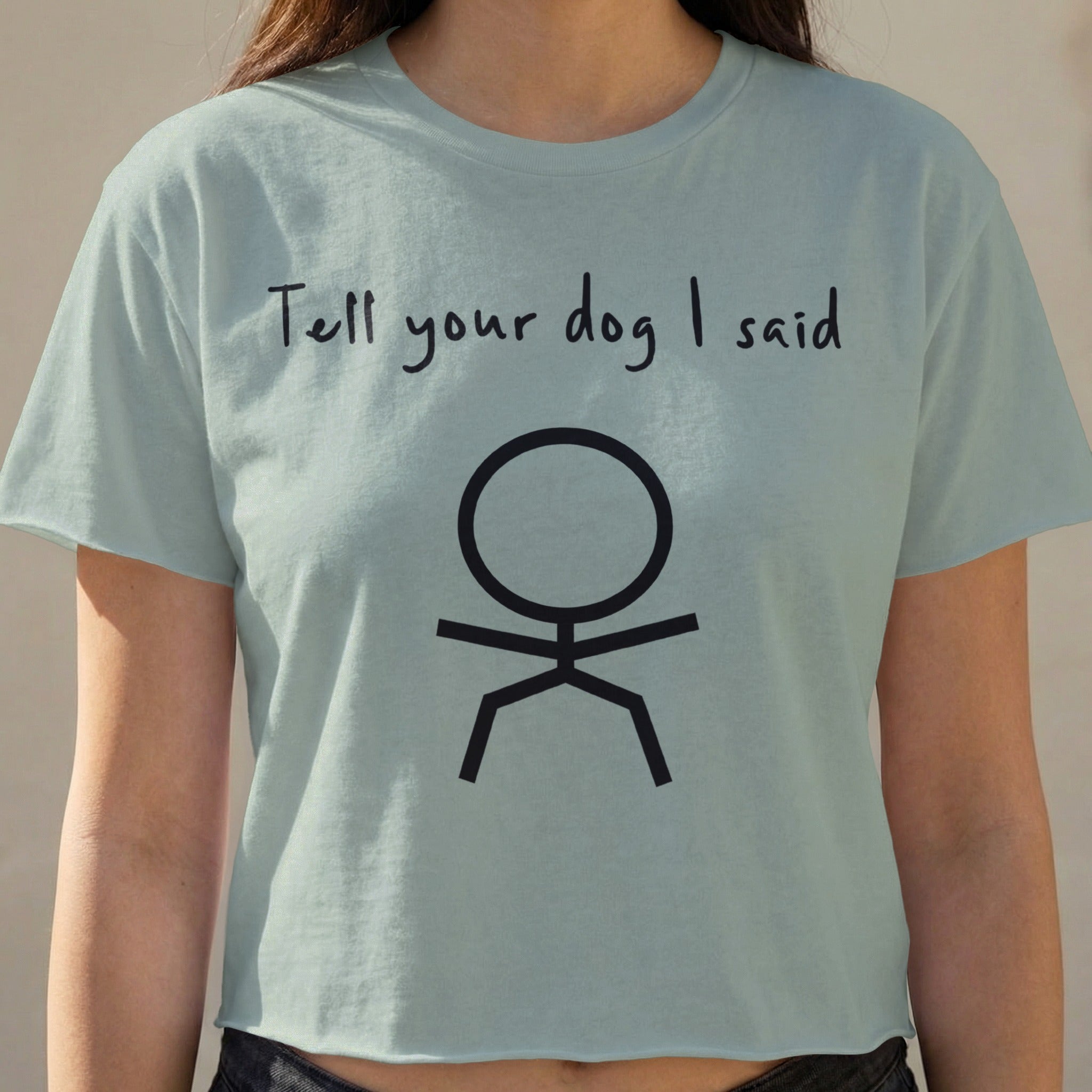 Light blue t-shirt with "Tell your dog I said" and a stick figure.