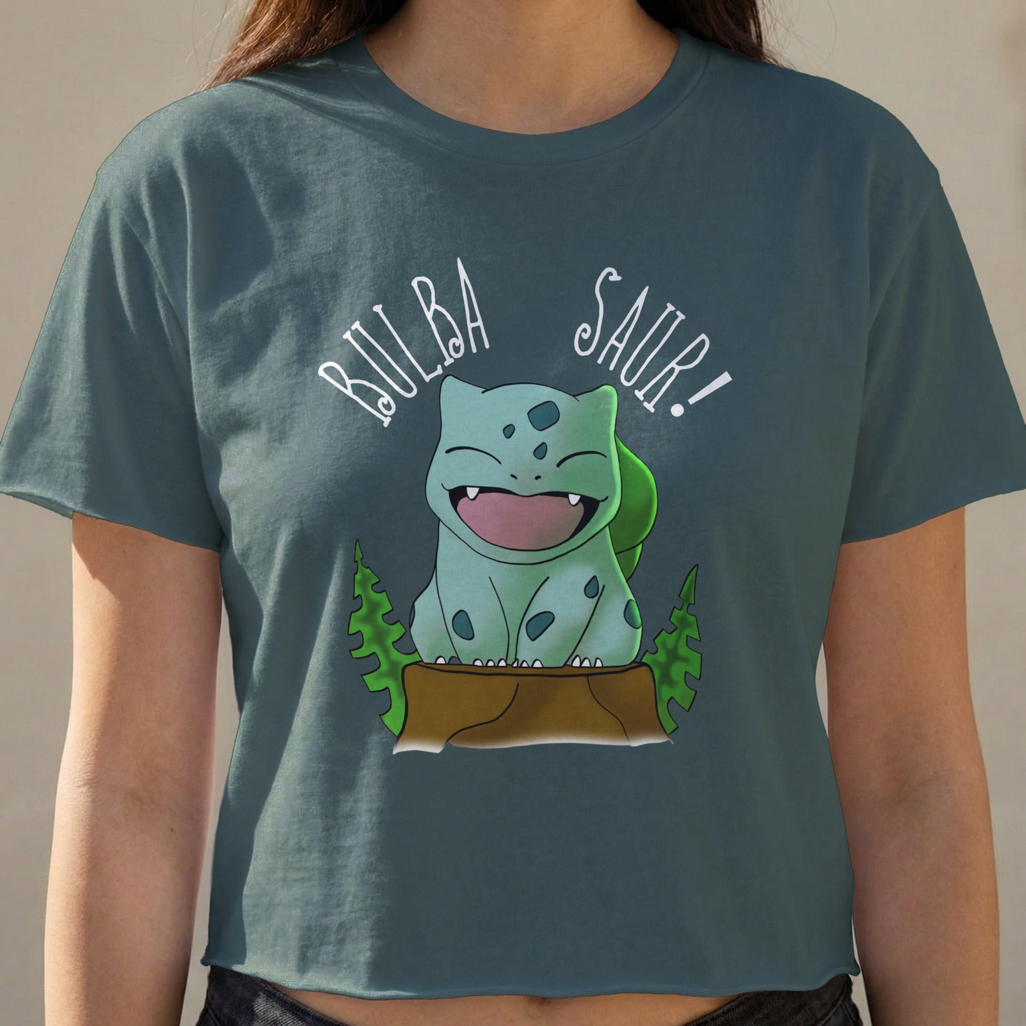 Bulbasaur graphic on a dark teal crop top, with "BULBA SAUR!" text.