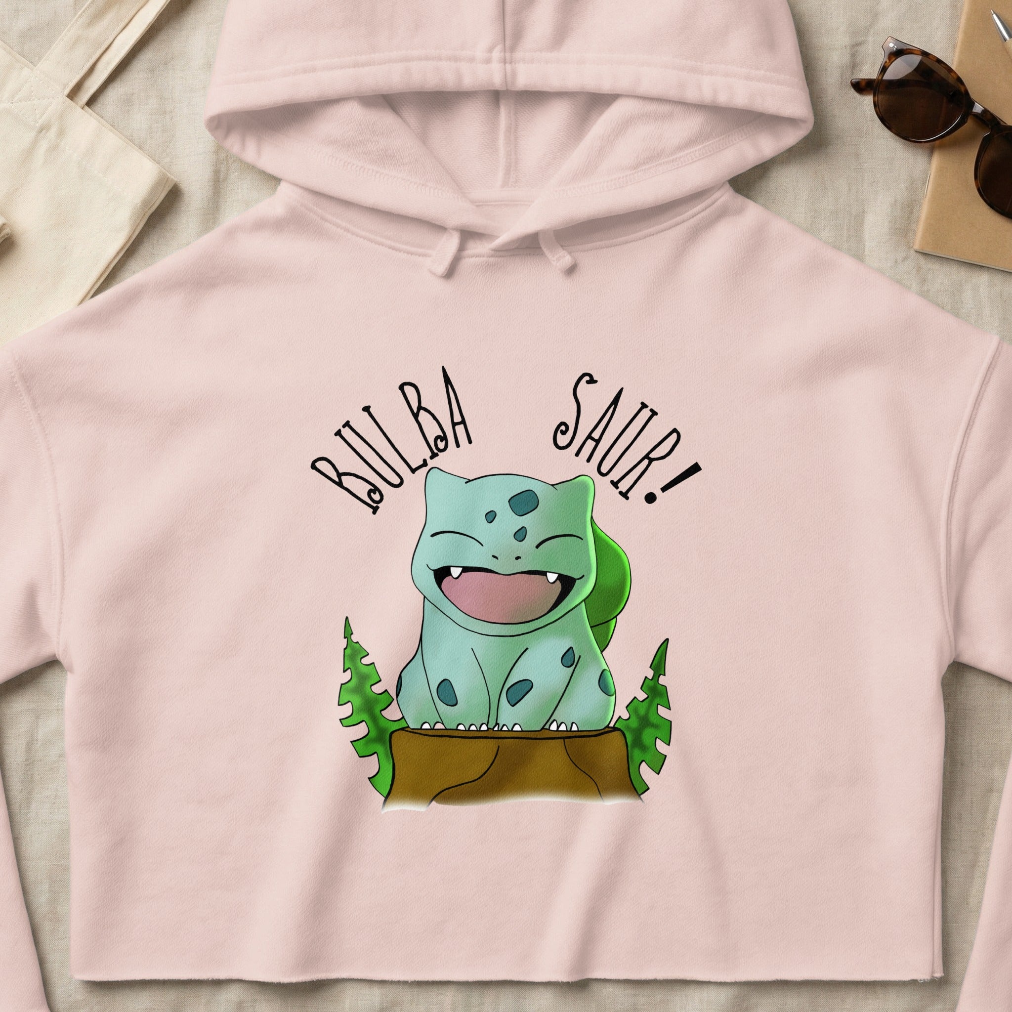 Light pink cropped hoodie with Bulbasaur graphic and text "Bulba Saur!"
