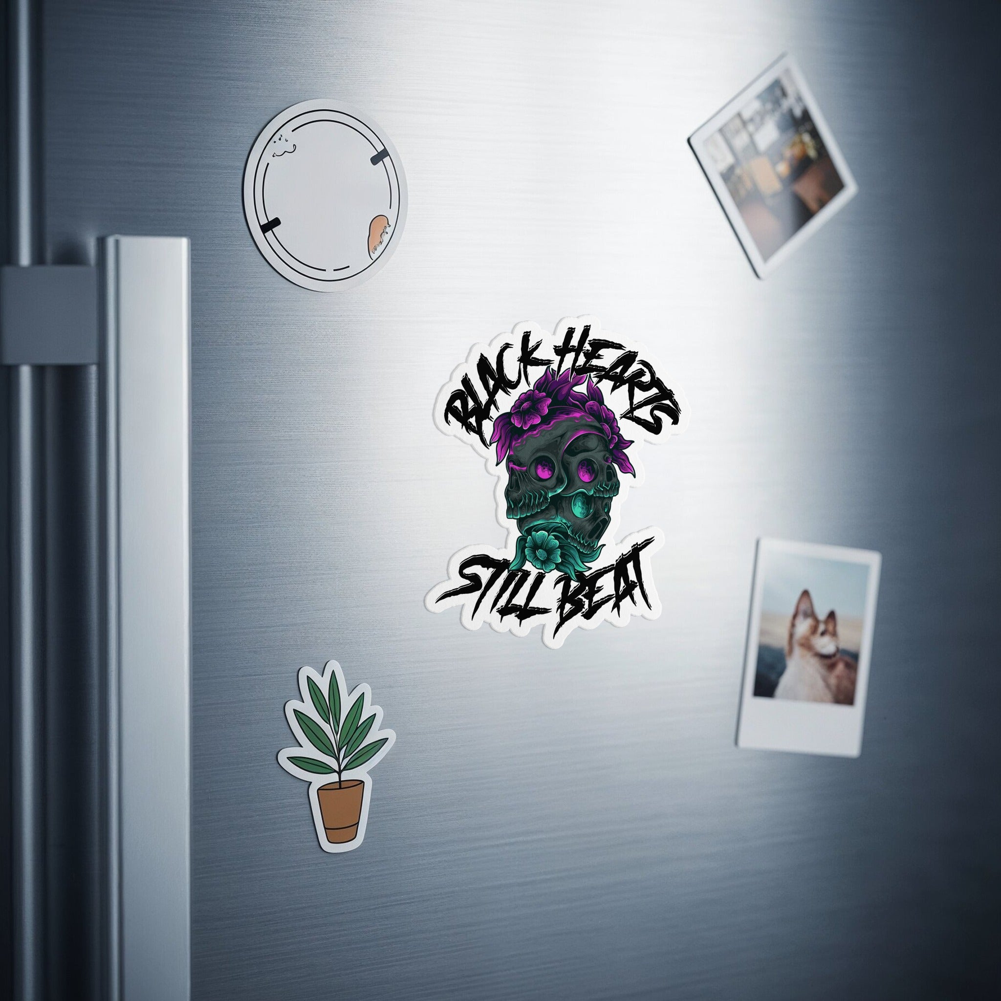 Skull sticker with "Black Hearts Still Beat" text, adorned with purple flowers.