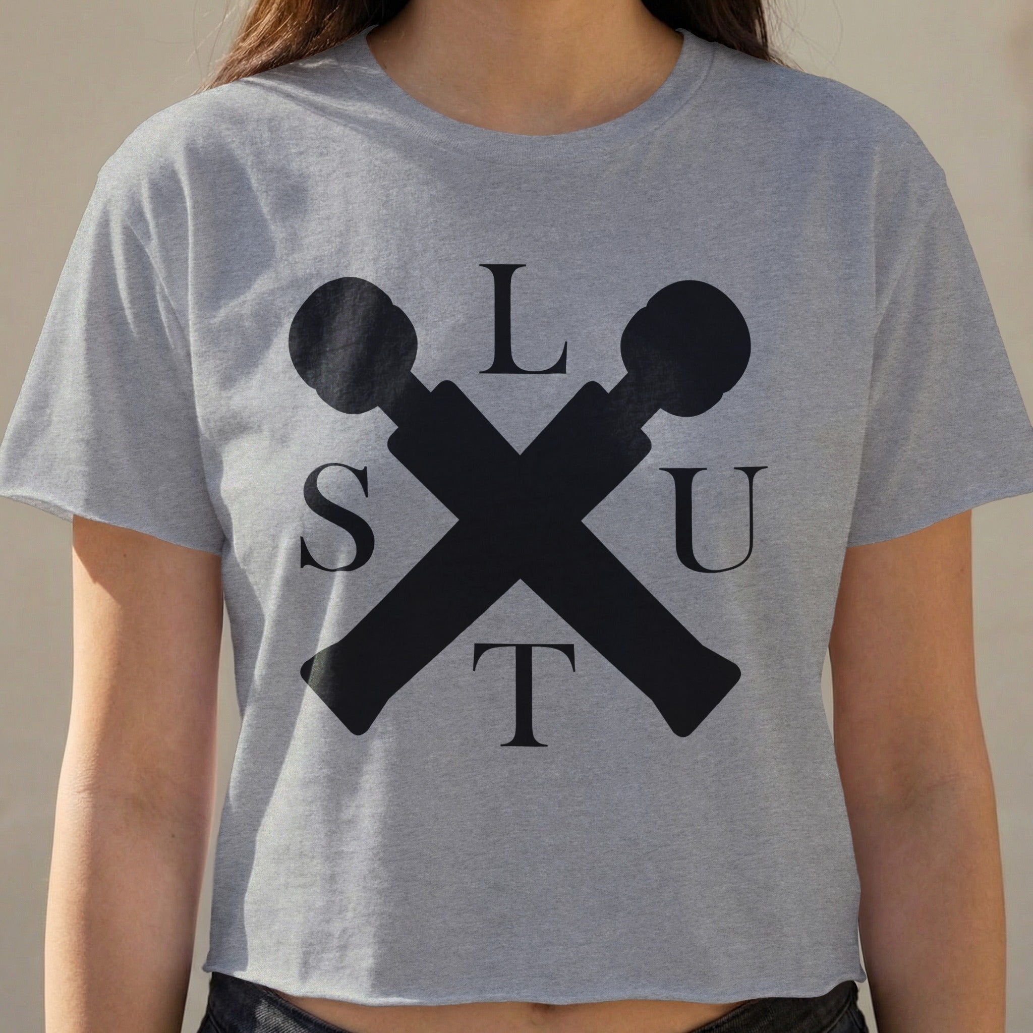 Cropped gray t-shirt with black crossed microphones and "SLUT" text.