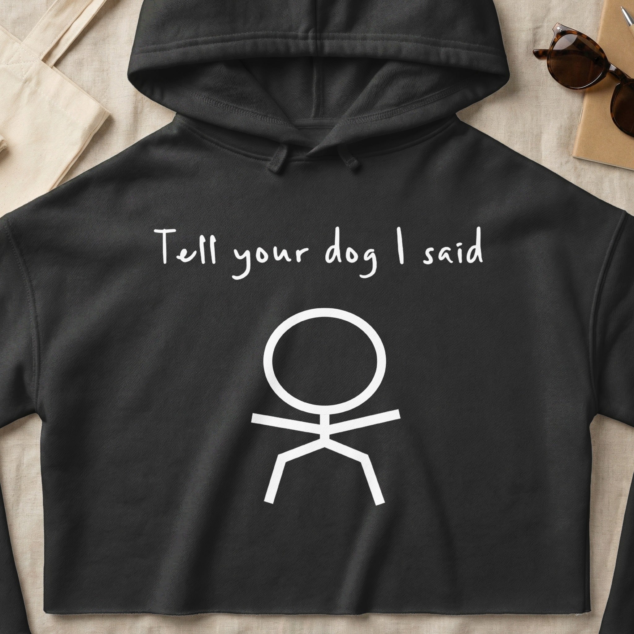 Black hoodie with "Tell your dog I said" and a stick figure drawing.