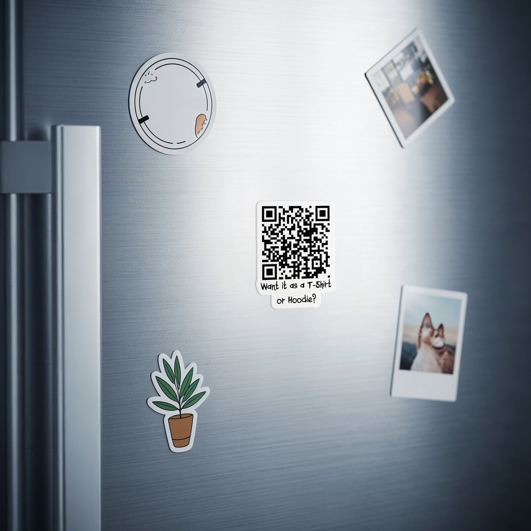 QR code sticker on a brushed metal surface with other magnets.
