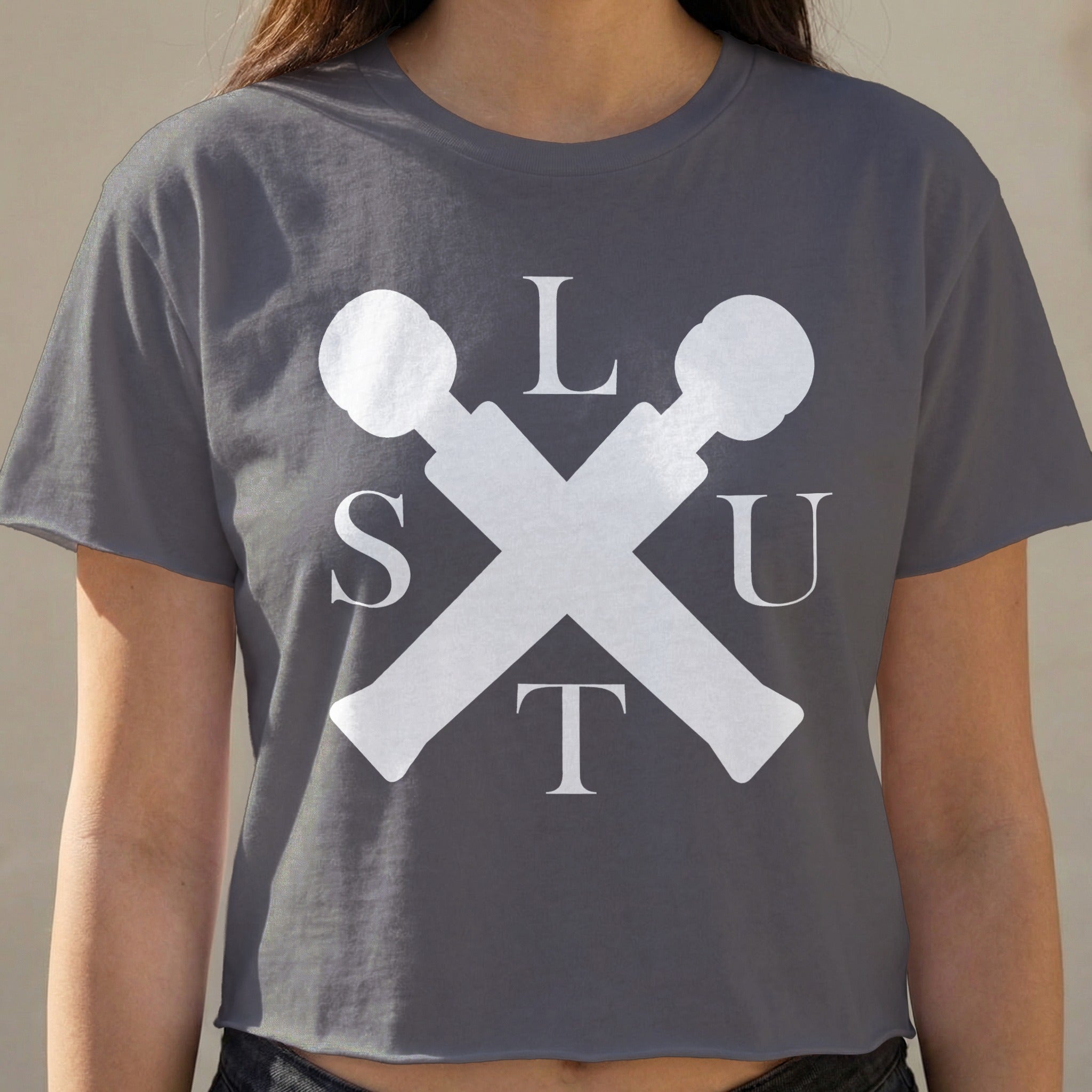 Dark grey cropped t-shirt with white "SLUT" lettering and crossed microphones graphic.