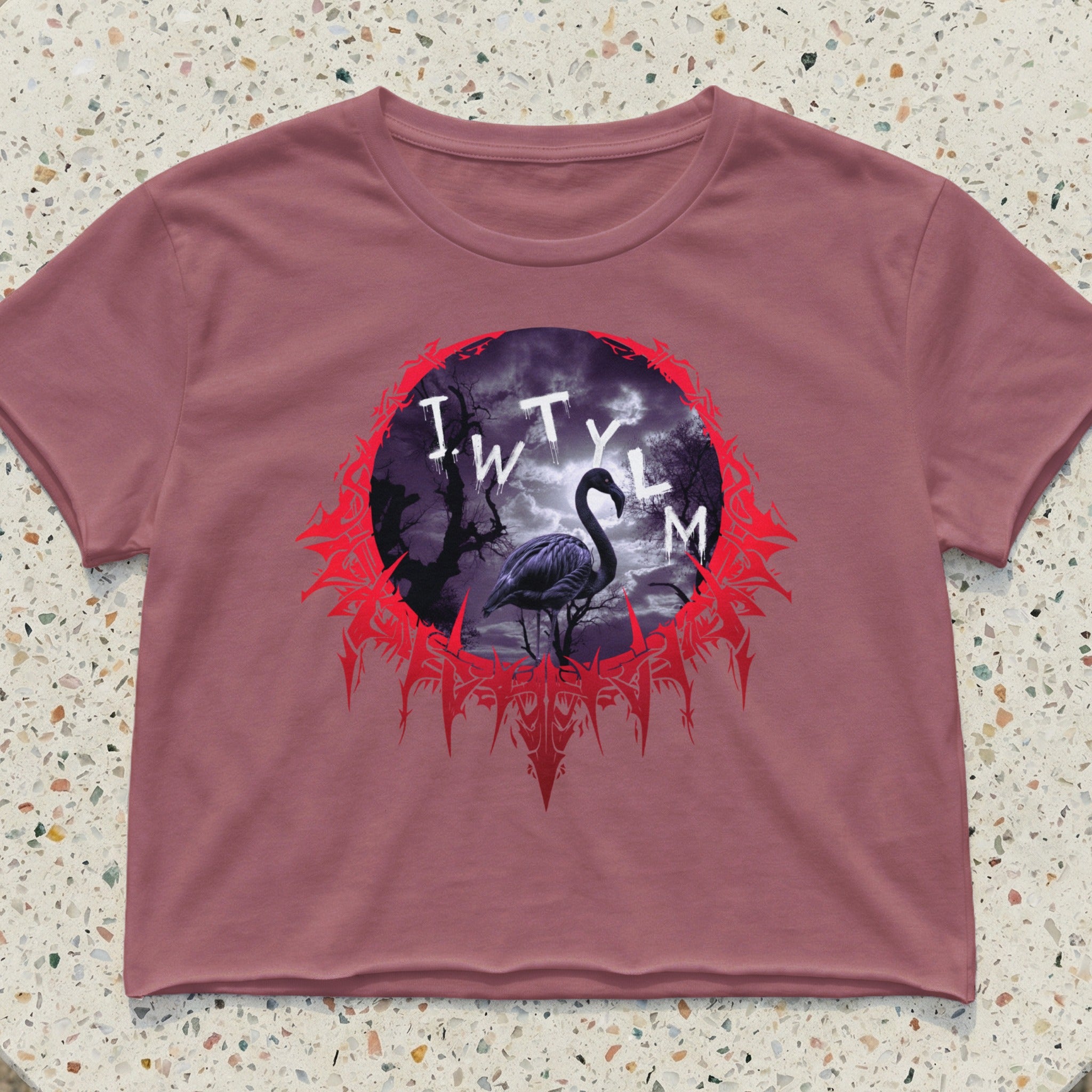Mauve crop top with a circular graphic featuring a flamingo in a dark, stormy forest.