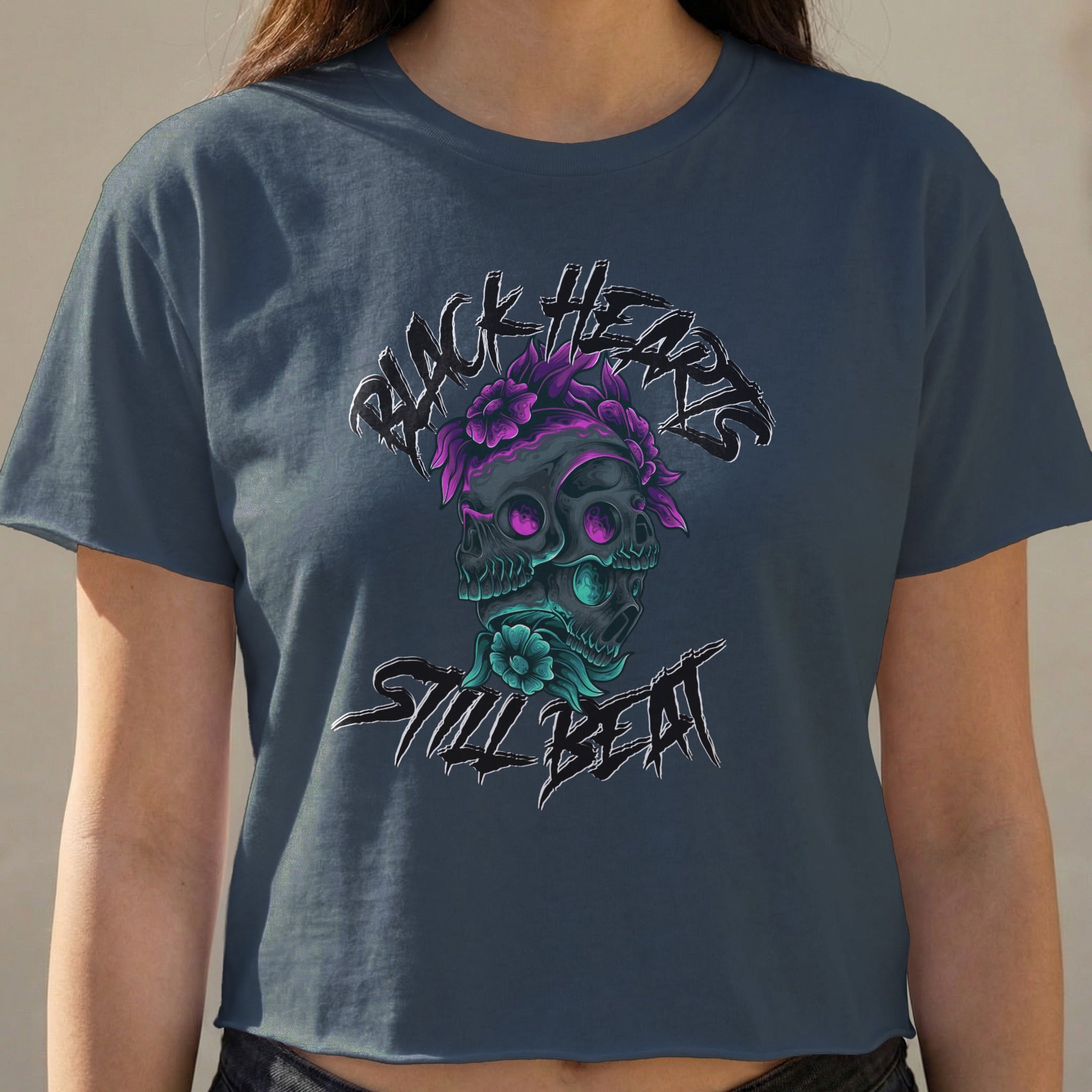 Dark t-shirt with "Black Hearts Still Beat" text and skull graphic.