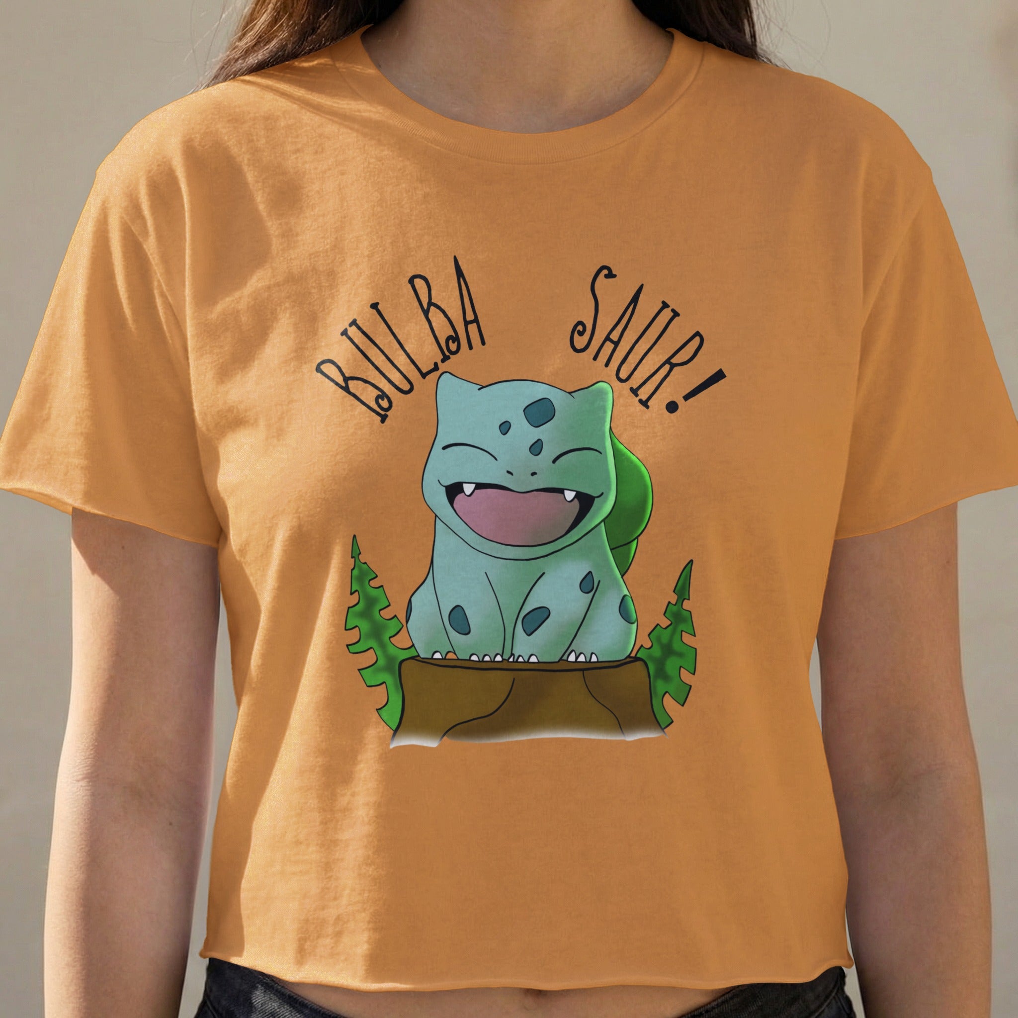 Bulbasaur with "Bulba Saur!" text on an orange graphic t-shirt.