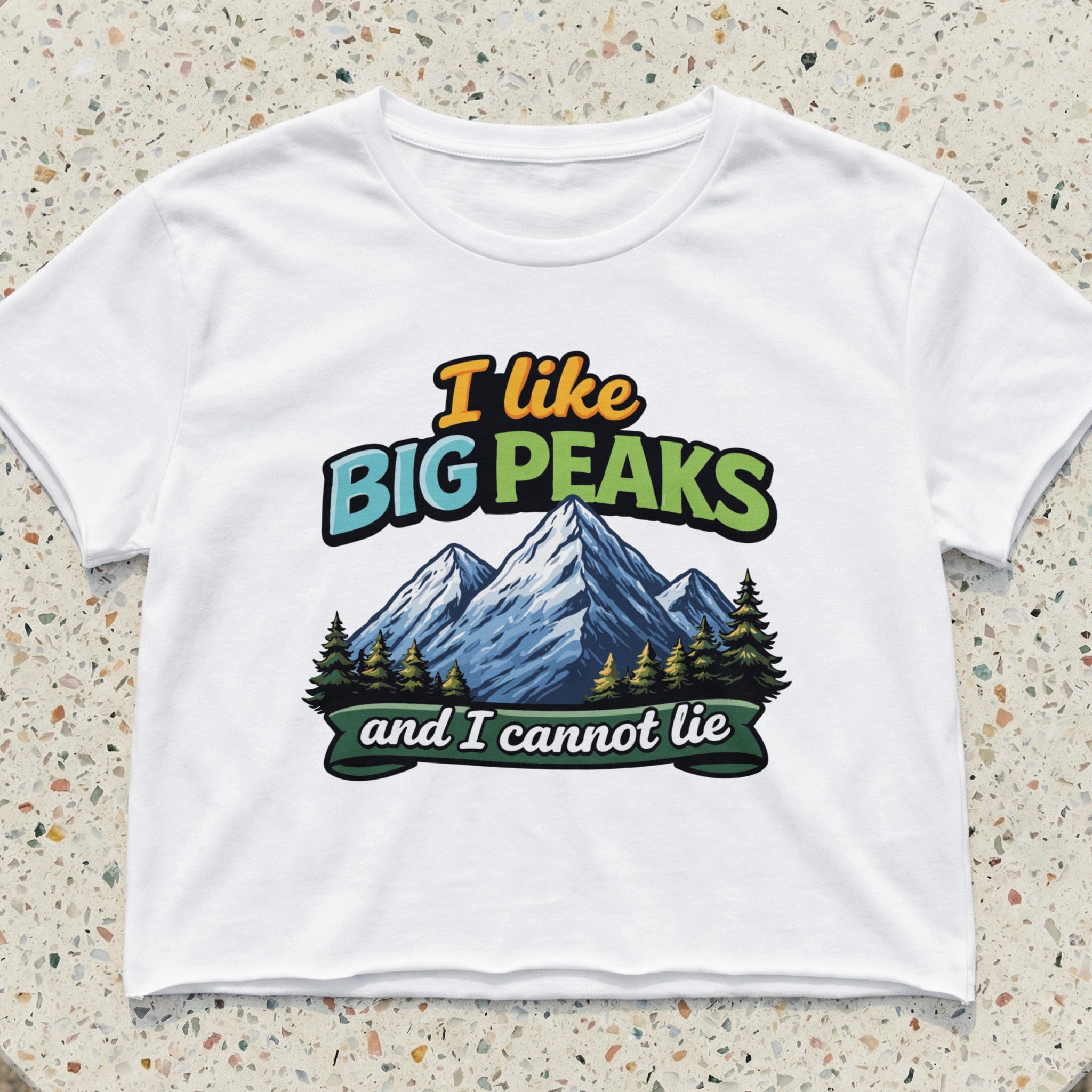 White t-shirt with "I like Big Peaks and I cannot lie" text and mountain graphic.