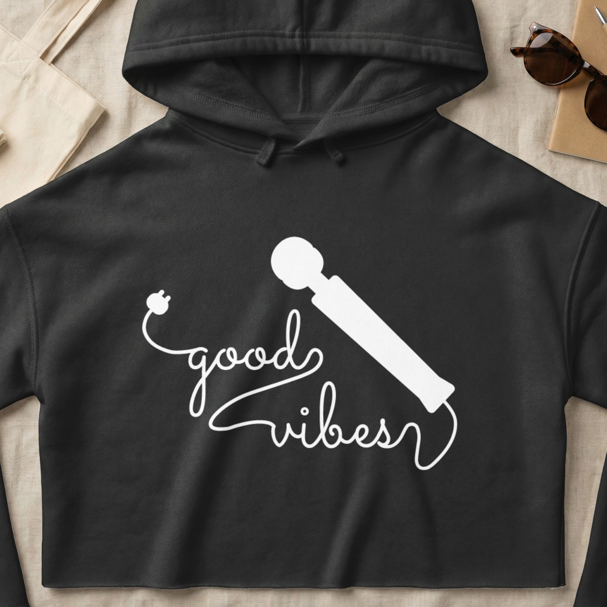 Black hoodie with "good vibes" text and a white silhouette of a personal massager.
