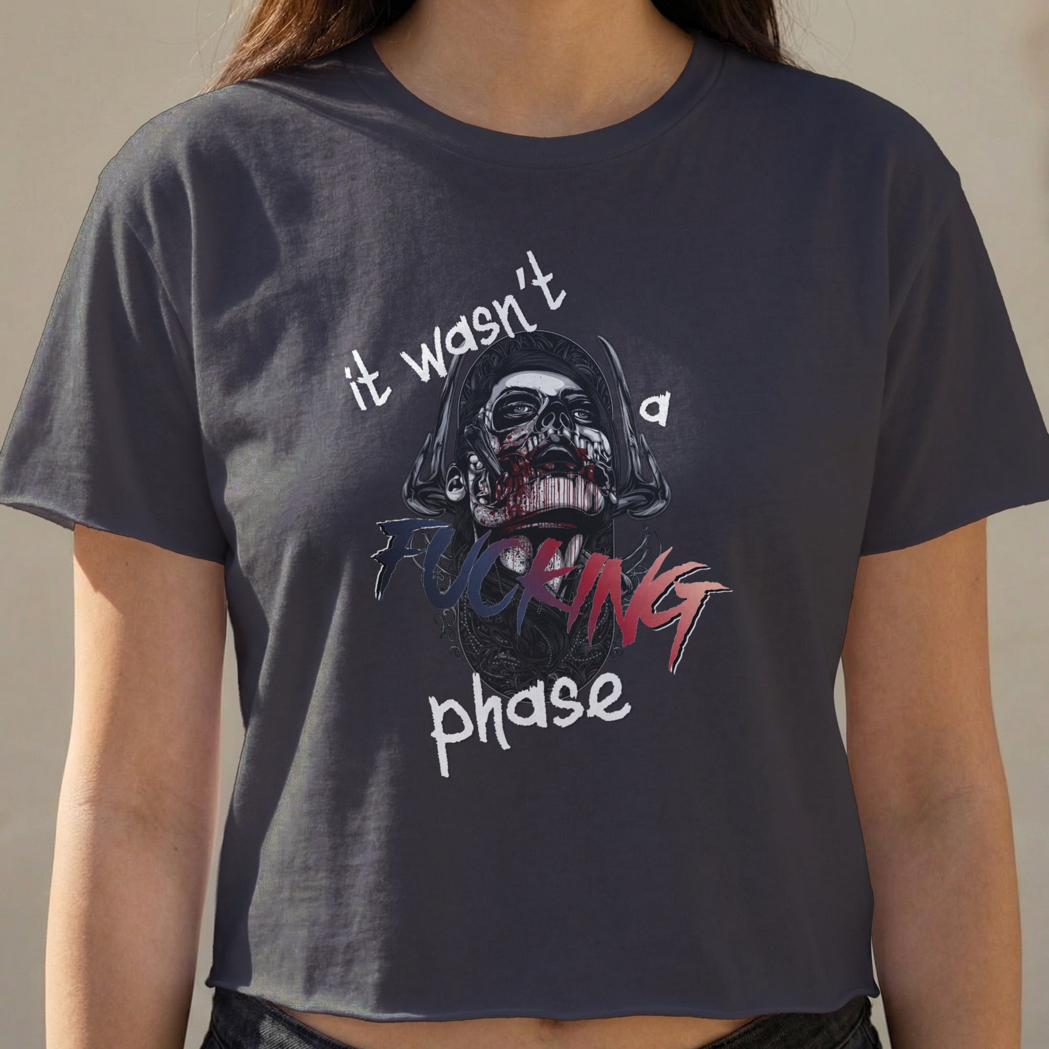 Dark t-shirt with skull graphic and text "it wasn't a fucking phase."