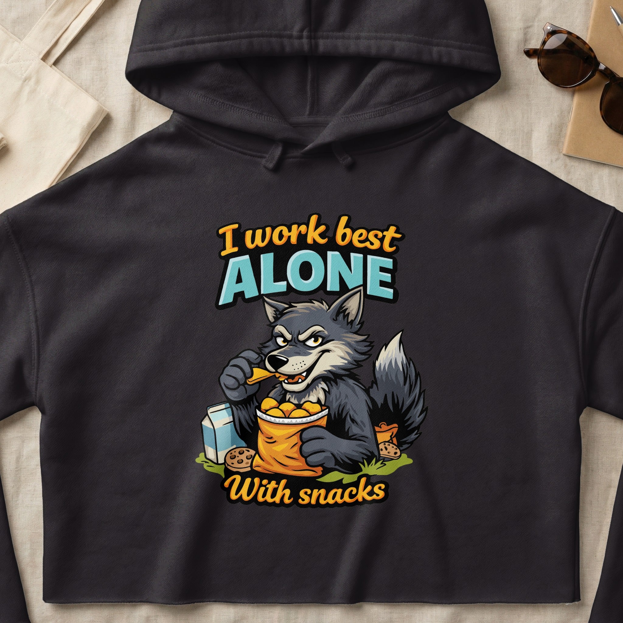Wolf eating snacks from a bag with text "I work best ALONE With snacks".