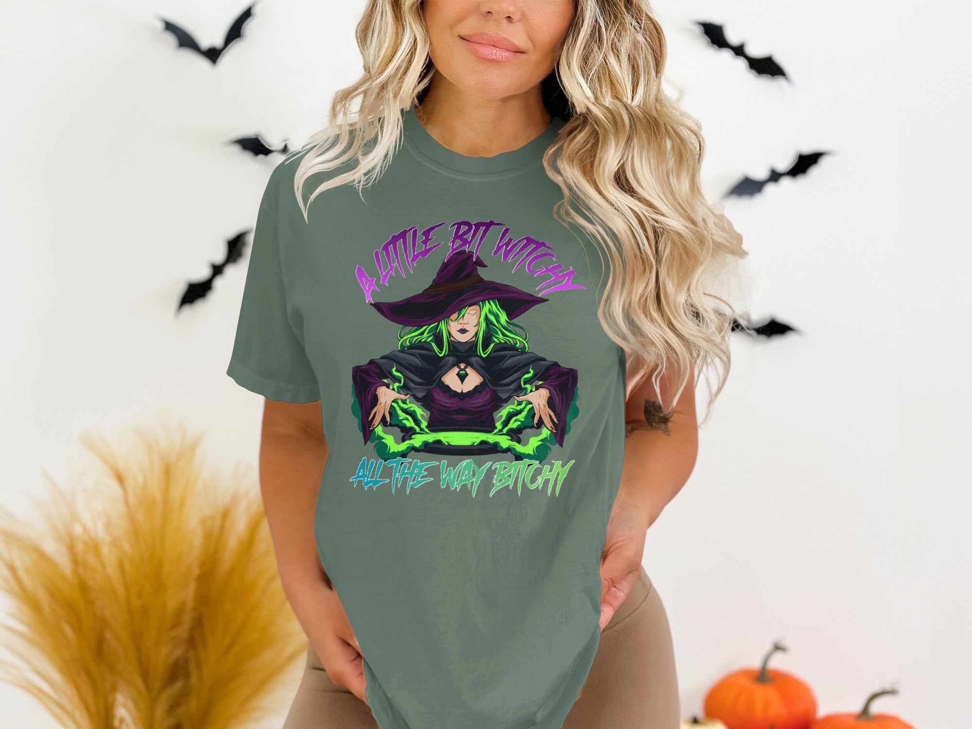 Green t-shirt with a witch illustration and text "A little bit witchy all the way bitchy".