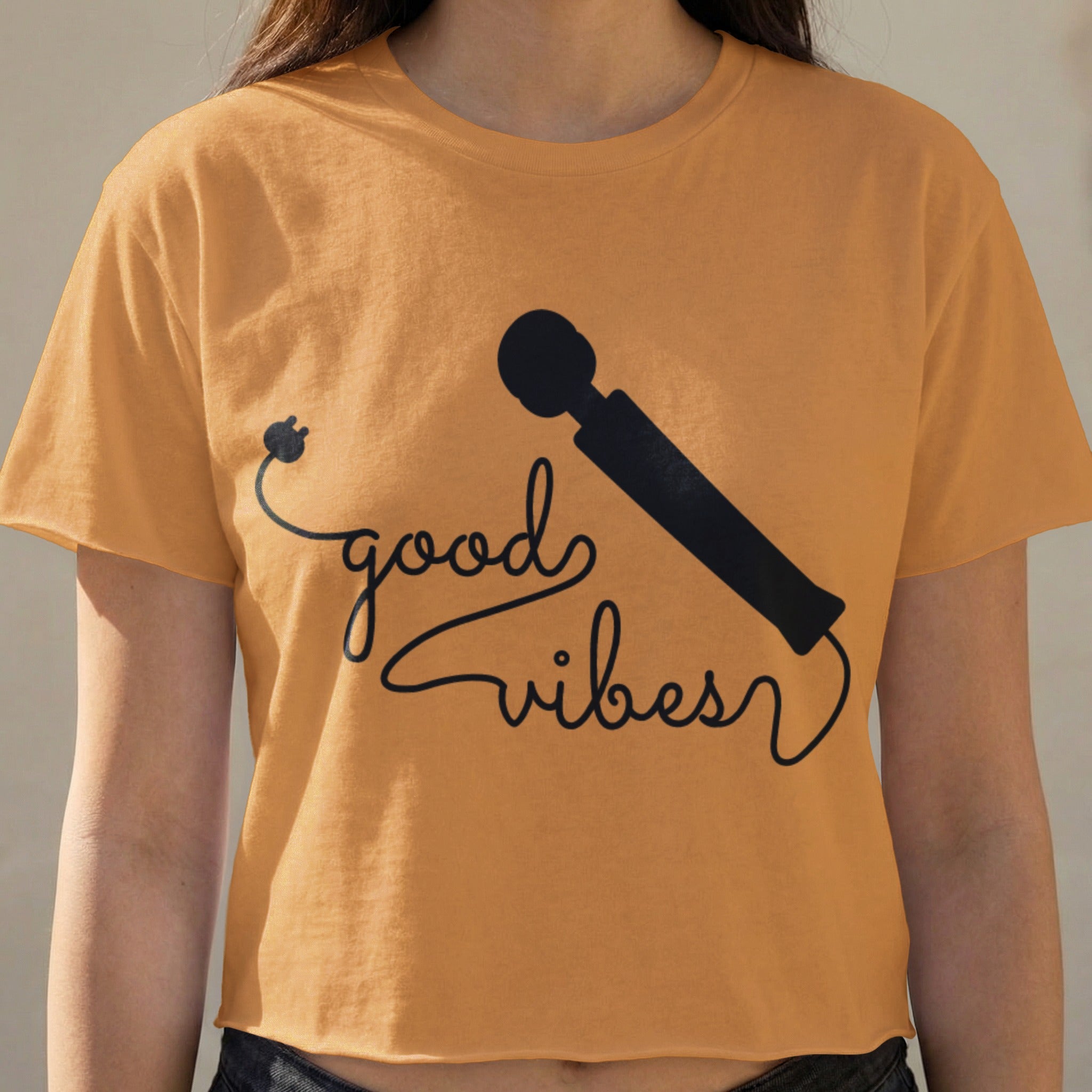 Orange t-shirt with "good vibes" text and microphone graphic.