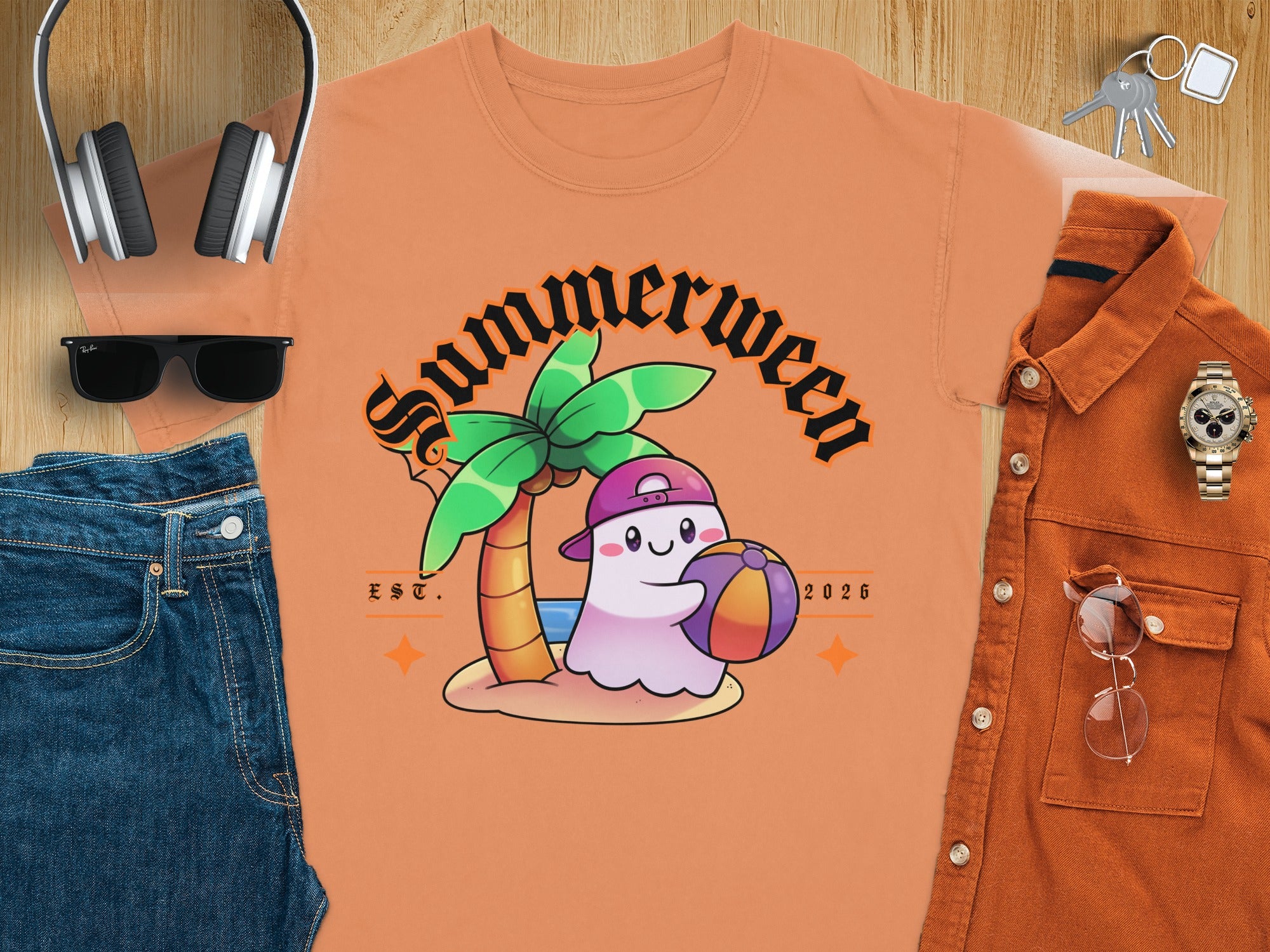 Peach t-shirt with cartoon ghost, palm tree, beach ball, and "Summerween EST. 2026" text.
