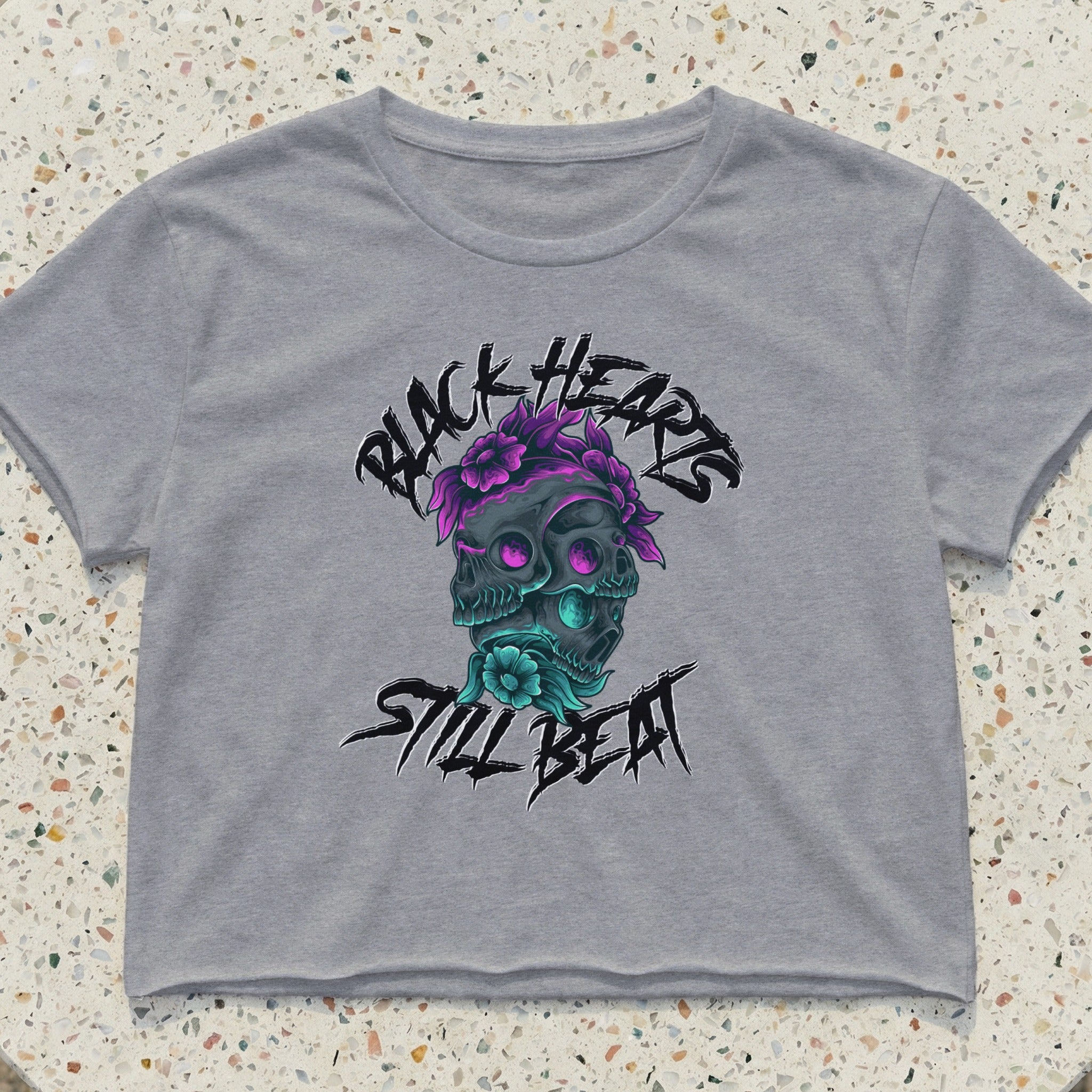 Grey cropped t-shirt with skull graphic and "Black Hearts Still Beat" text.