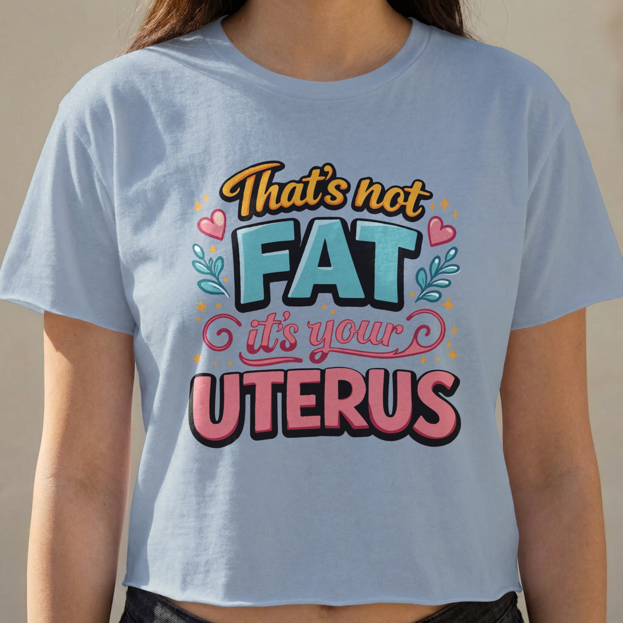 Light blue cropped t-shirt with "That's not FAT it's your UTERUS" text.