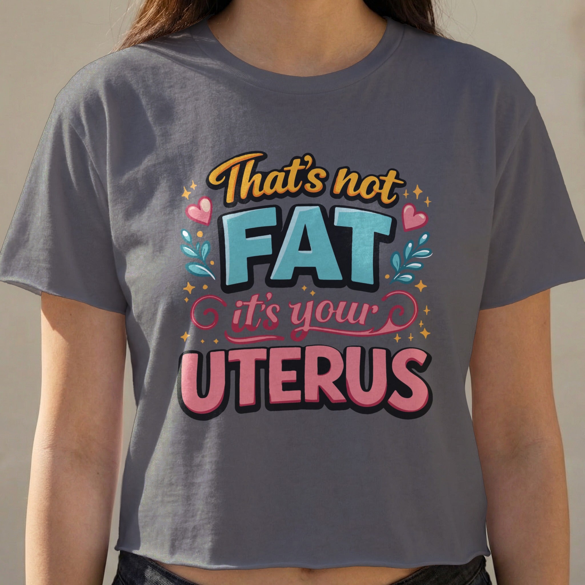 Crop top with text "That's not FAT it's your UTERUS" in colorful lettering.
