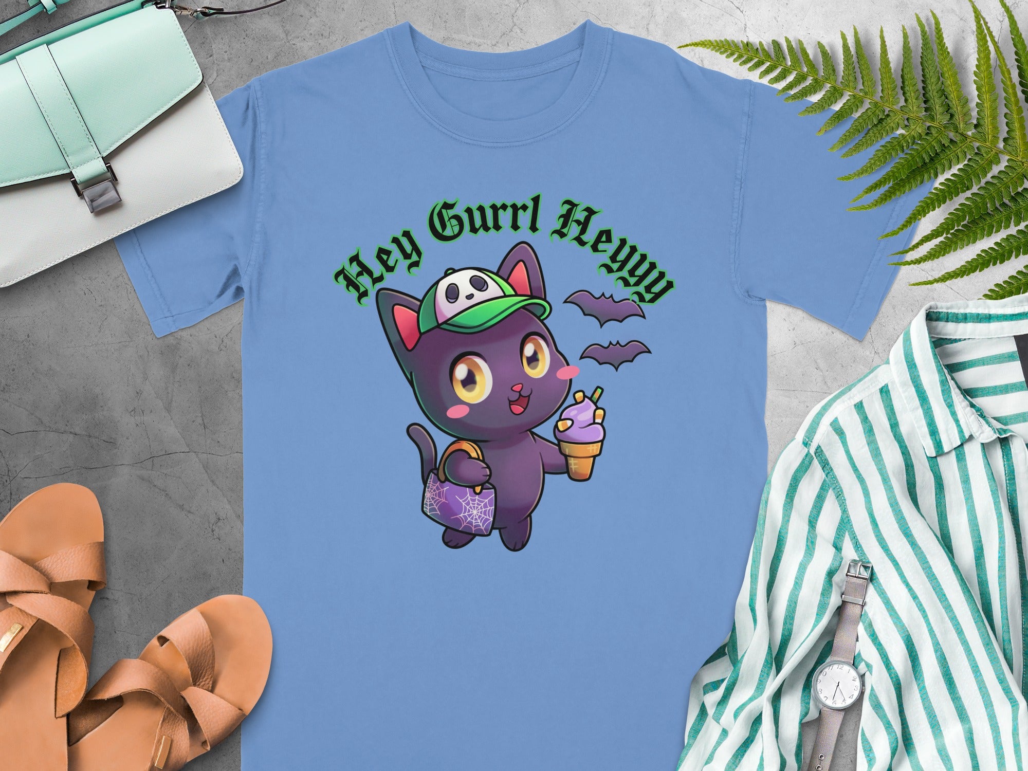 Blue t-shirt with cartoon black cat holding ice cream and handbag, text "Hey Gurrl Heyyy".