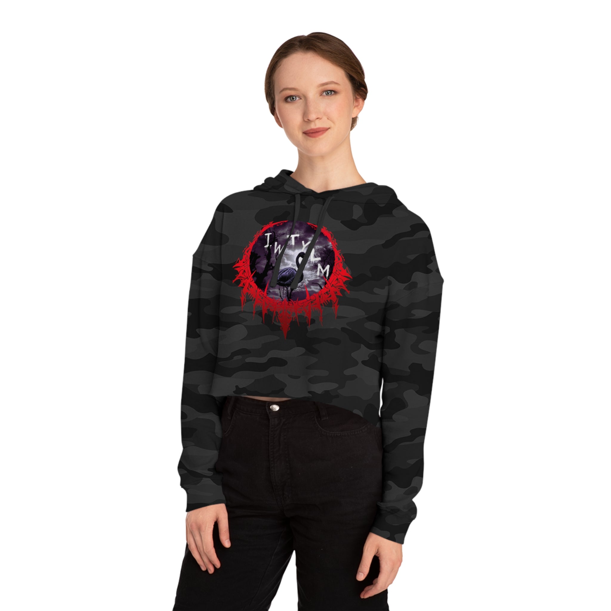 Woman wearing a black camouflage cropped hoodie with a circular graphic logo.
